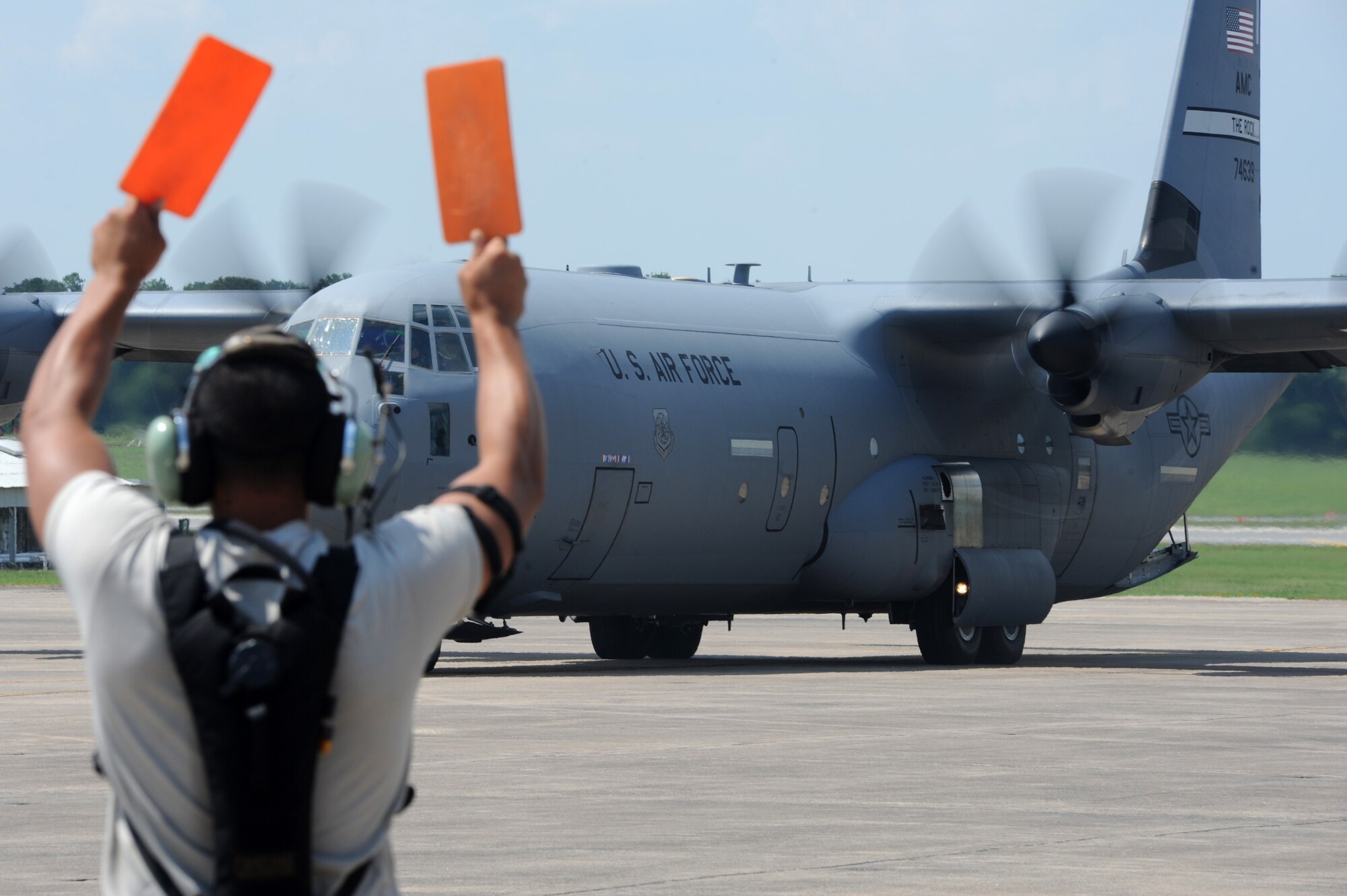 A 19th Aircraft Maintenance Squadron crew chief marshals a C-130 in preparation for the Air Mobility Command RODEO, July 15, 2011, at Little Rock Air Force Base, Ark. For this year’s competition, more than 150 teams and 3,000 people from the Air Force and Air Force Reserve, as well as allied nations, are expected to participate. (U.S. Air Force photo by Airman 1st Class Rusty Frank)