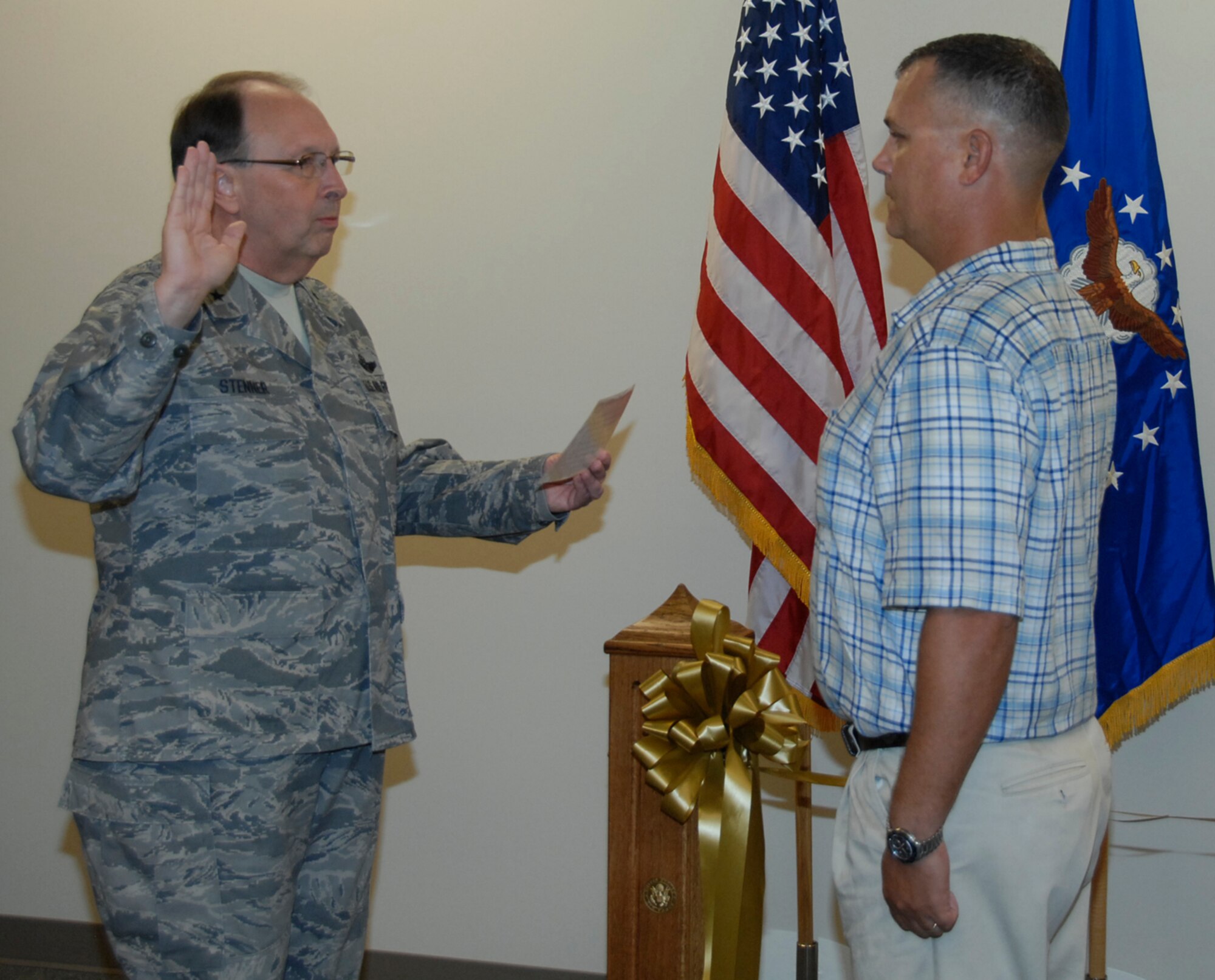 Lt. Gen. Charles E. Stenner Jr., left, commander of Air Force Reserve Command, administers the oath of enlistment to Staff Sgt. Christopher Earl Johnson, July 15, 2011. Johnson is a prior-service Marine, who enlisted in the Air Force Reserve as a traditional reservist in the 55th Combat Communications Squadron at Robins Air Force Base, Ga. (U.S. Air Force photo/Claude Lazzara)