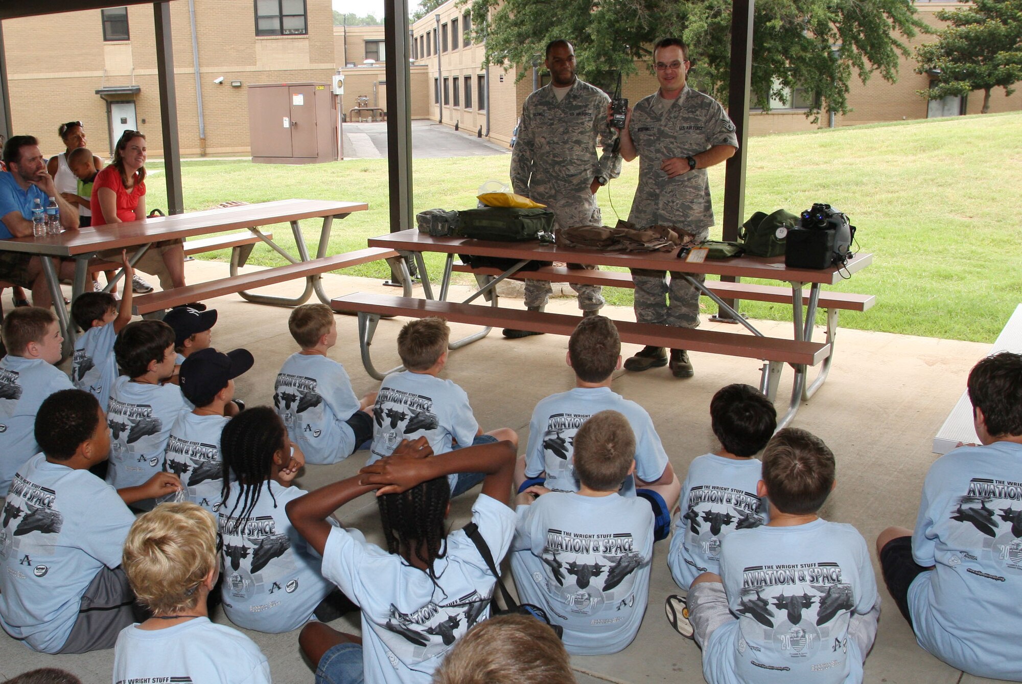 Technical Sgt. Preston R. Caldwell and Staff Sgt. Sean R. McDermott from the life support section, 700th Airlift Squadron demonstrate equipment required by air crews. (U.S. Air Force Photo/Don Peek)