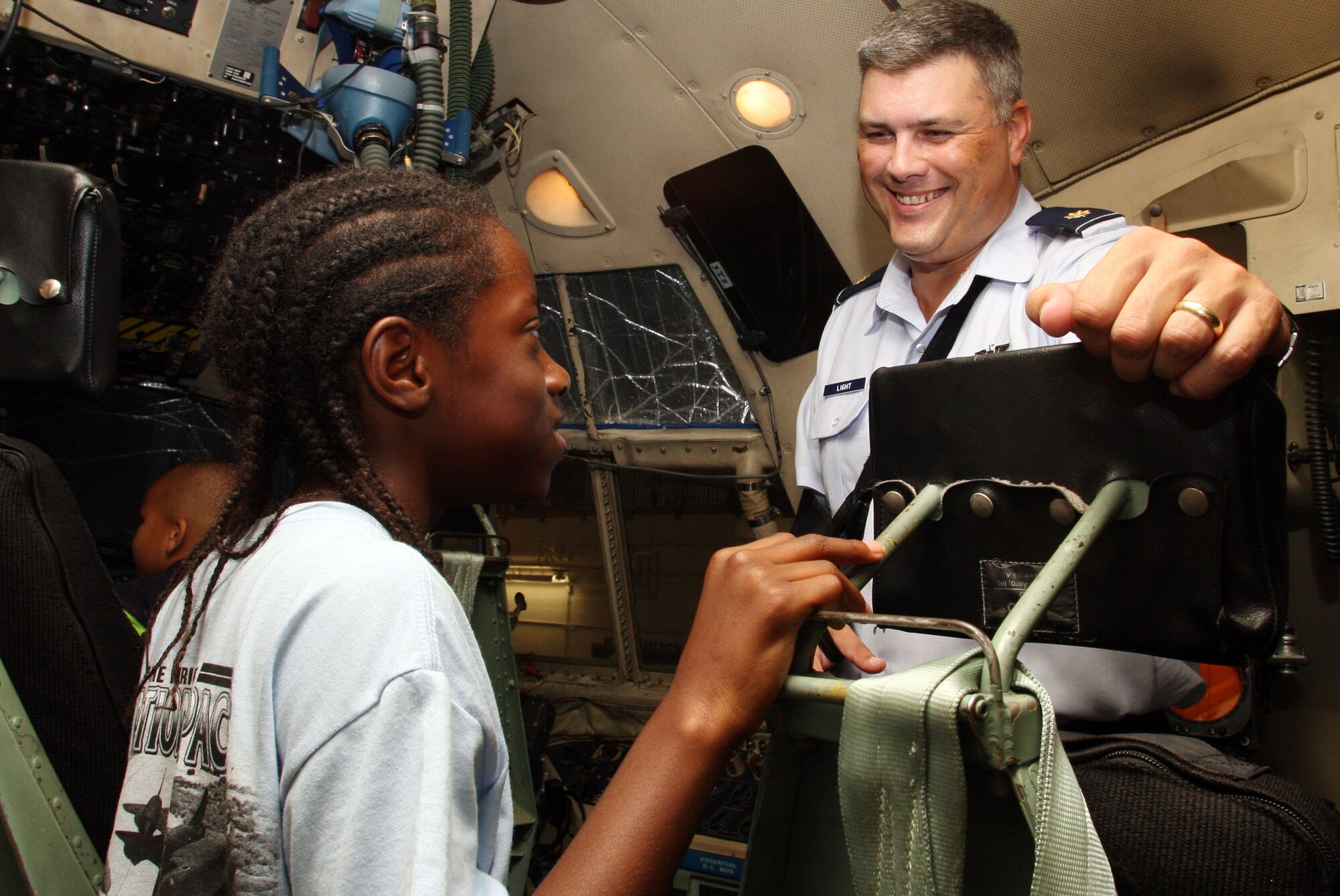 Maj. James R. Light, instructor pilot with the 700th Airlift Squadron, answers questions about the C-130 from one of the "Wright" Stuff campers during their tour here July 15, 2011. (U.S. Air Force Photo/Don Peek)