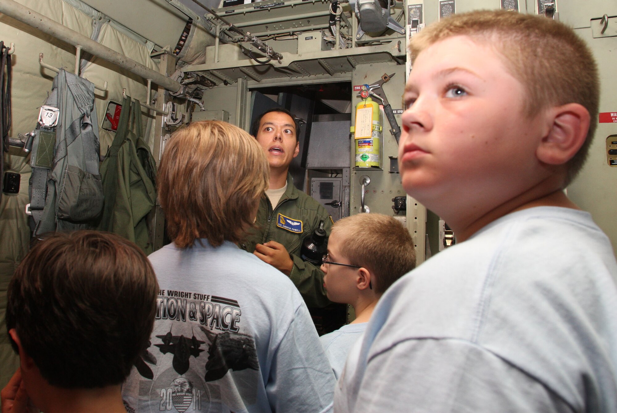 The "Wright" Stuff campers learn about the cargo area of the C-130 from Airman 1st Class Andrew A. Powell a loadmaster with the 700th Airlift Squadron during their tour July 15, 2011. (U.S. Air Force Photo/Don Peek)