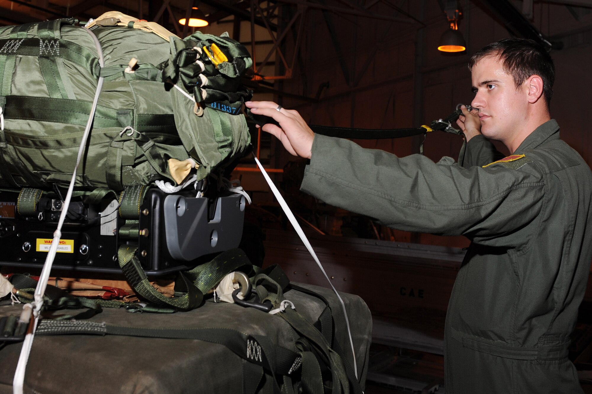 Senior Airman Jonathan Perry, a 19th Operation Support Squadron joint air drop inspector, inspects the release away static line for a Joint Precision Air Drop System, July 14, 2011, at Little Rock Air Force Base, Ark. Perry is currently training to compete in the Air Mobility Command RODEO 2011, held at McChord Field on Joint Base Lewis-McChord, Wash., from July 24 to July 29. (U.S. Air Force photo by Tech. Sgt. Chad Chisholm)