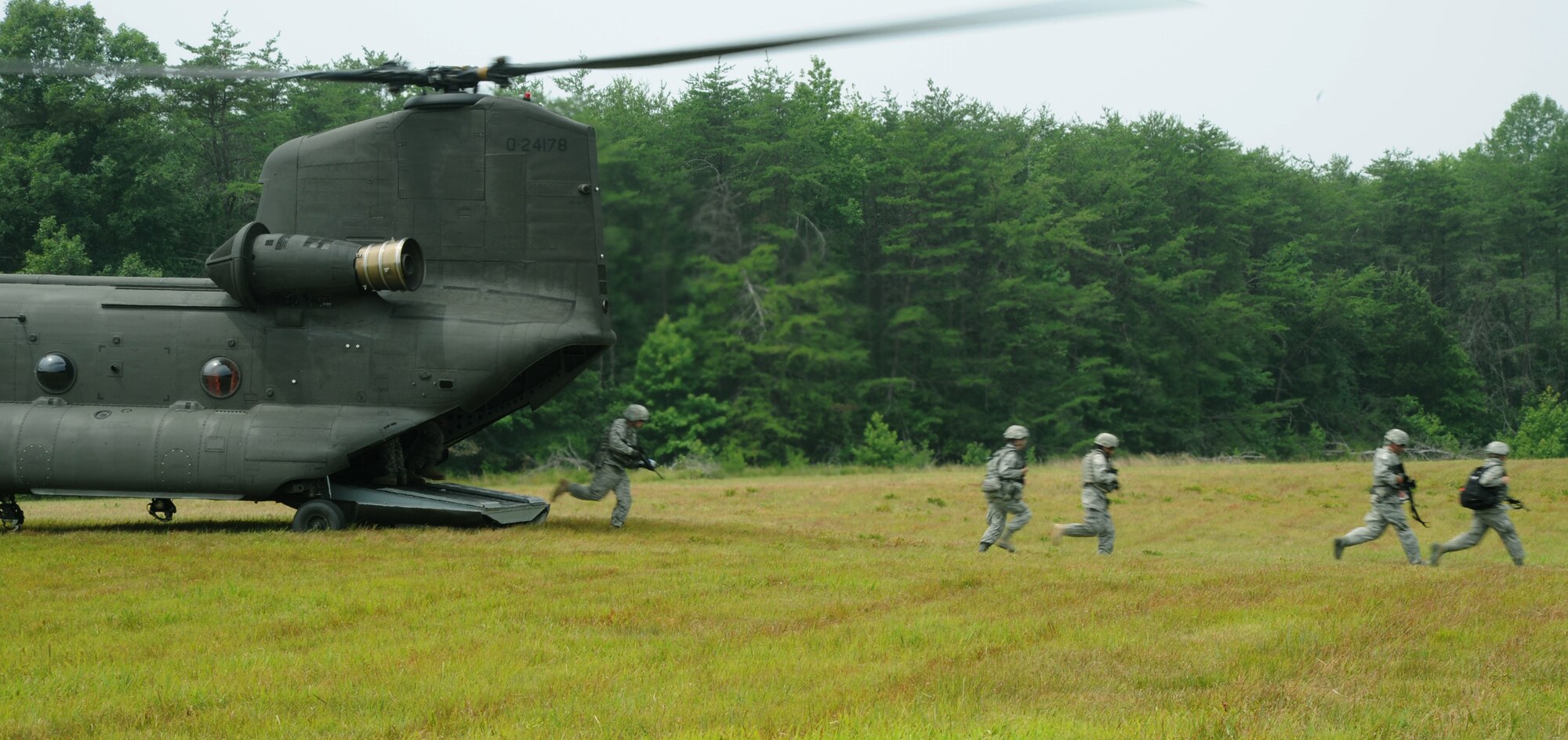 Members of the 11th Wing Security Forces Squadron and the 55th Signal Company unload from a U.S. Army CH-47 Chinook as they train for combat operations near Brandywine, Md. July 19.  Members of the 89th Communications Squadron from Joint Base Andrews and 579th Medical Group from Joint Base Annacostia-Bolling, Washington, D.C., also attended the training. (U.S. Air Force photo by Senior Airman Torey Griffith)