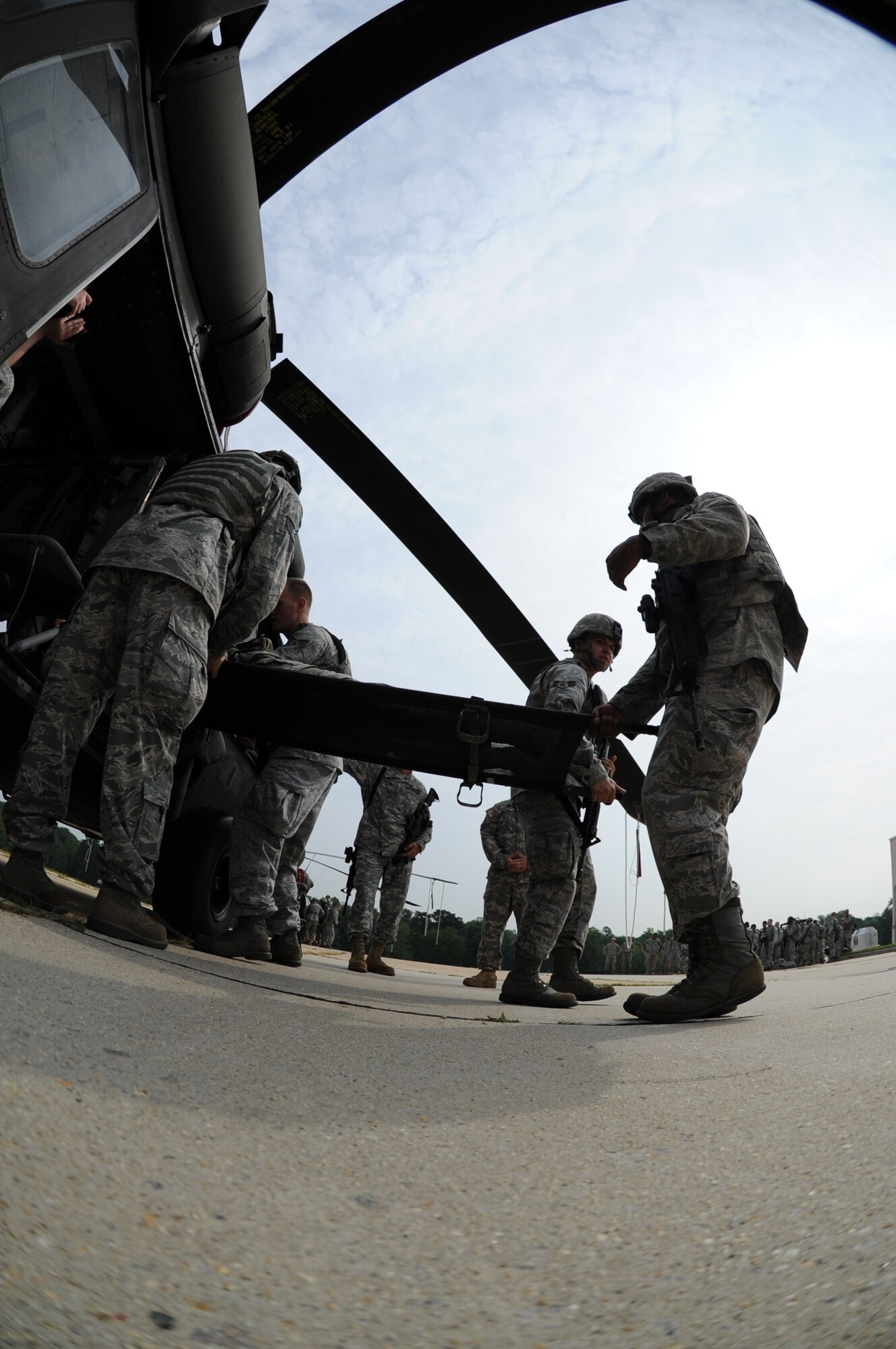 11th Wing Security Forces Airmen load a litter onto a static CH-60 Blackhawk as they train for airborne operations at Davidson Army Airfeild, Va. July 19.  Members of the 89th Communications Squadron from Joint Base Andrews, Md., 579th Medical Group from Joint Base Annacostia-Bolling, and the 55th Signal Company from Fort Meade, Md. also attended the training. (U.S. Air Force photo by Senior Airman Torey Griffith)