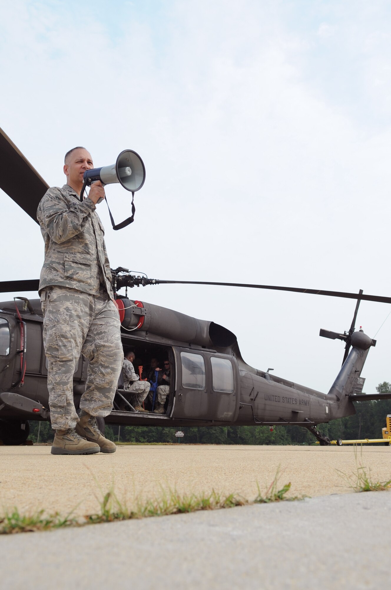 Lieutenant Colonel Kjäll Gopaul, Director of Joint and Air Staff Liason at the LeMay Center for Doctrine Development and Education at the Pentagon, instructs Airmen and Soldiers training for Tactical Air Operations on a static UH-60 Black Hawk at Davidson Army Airfeild, Va., June 19.  The goal was to familiarize servicemembers with procedures to enter, exit and defend helicopters in a deployed environment. (U.S. Air Force photo by Senior Airman Torey Griffith)