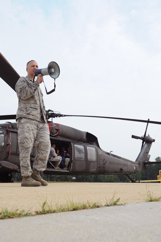 Lieutenant Colonel Kjäll Gopaul, Director of Joint and Air Staff Liason at the LeMay Center for Doctrine Development and Education at the Pentagon, instructs Airmen and Soldiers training for Tactical Air Operations on a static UH-60 Black Hawk at Davidson Army Airfeild, Va., June 19.  The goal was to familiarize servicemembers with procedures to enter, exit and defend helicopters in a deployed environment. (U.S. Air Force photo by Senior Airman Torey Griffith)