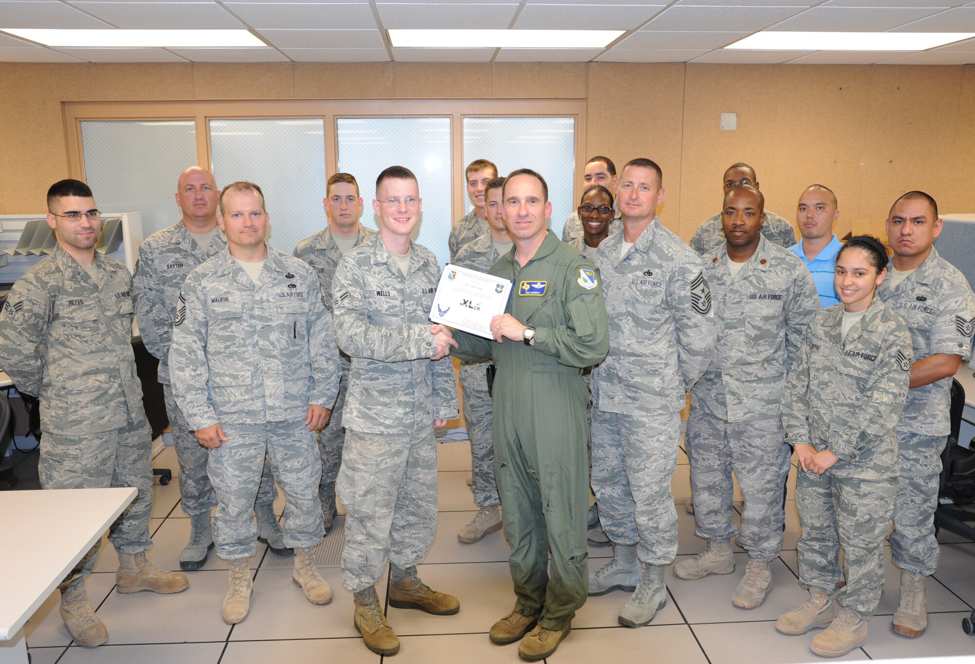 LAUGHLIN AIR FORCE BASE, Texas – Airman 1st Class Seth Wells, 47th Communications Squadron, poses with Col. Thomas Murphy, 47th Flying Training Wing vice commander, after being presented the XLer of the Week award here July 13. The XLer is a weekly award chosen by wing leadership and given to those who consistently make outstanding contributions to Laughlin and their unit. (U.S. Air Force photo by Airman 1st Class Blake Mize)