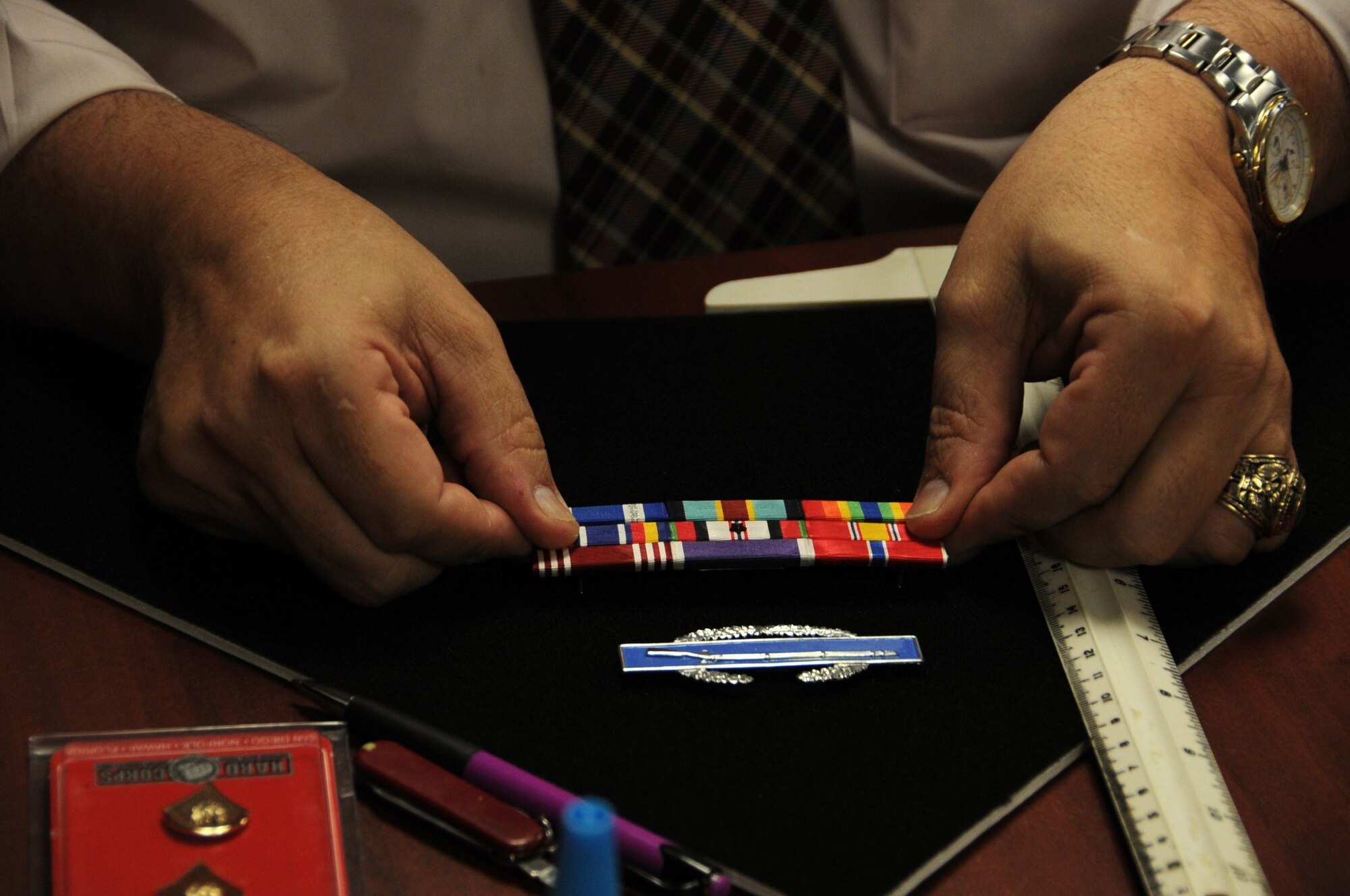 Mark Pieklik, Ft. Dix Casualty Assistance Center Casualty Operations Coordinator, may do one of the most significant and memorable things for the Families and their Fallen Soldiers. He is responsible for preparing the flag case with the deceased Soldier’s rank, ribbon rack, badges and awards on a black felt board. (U.S. Air Force photo by Airman 1st Class Dennis Sloan/Released)