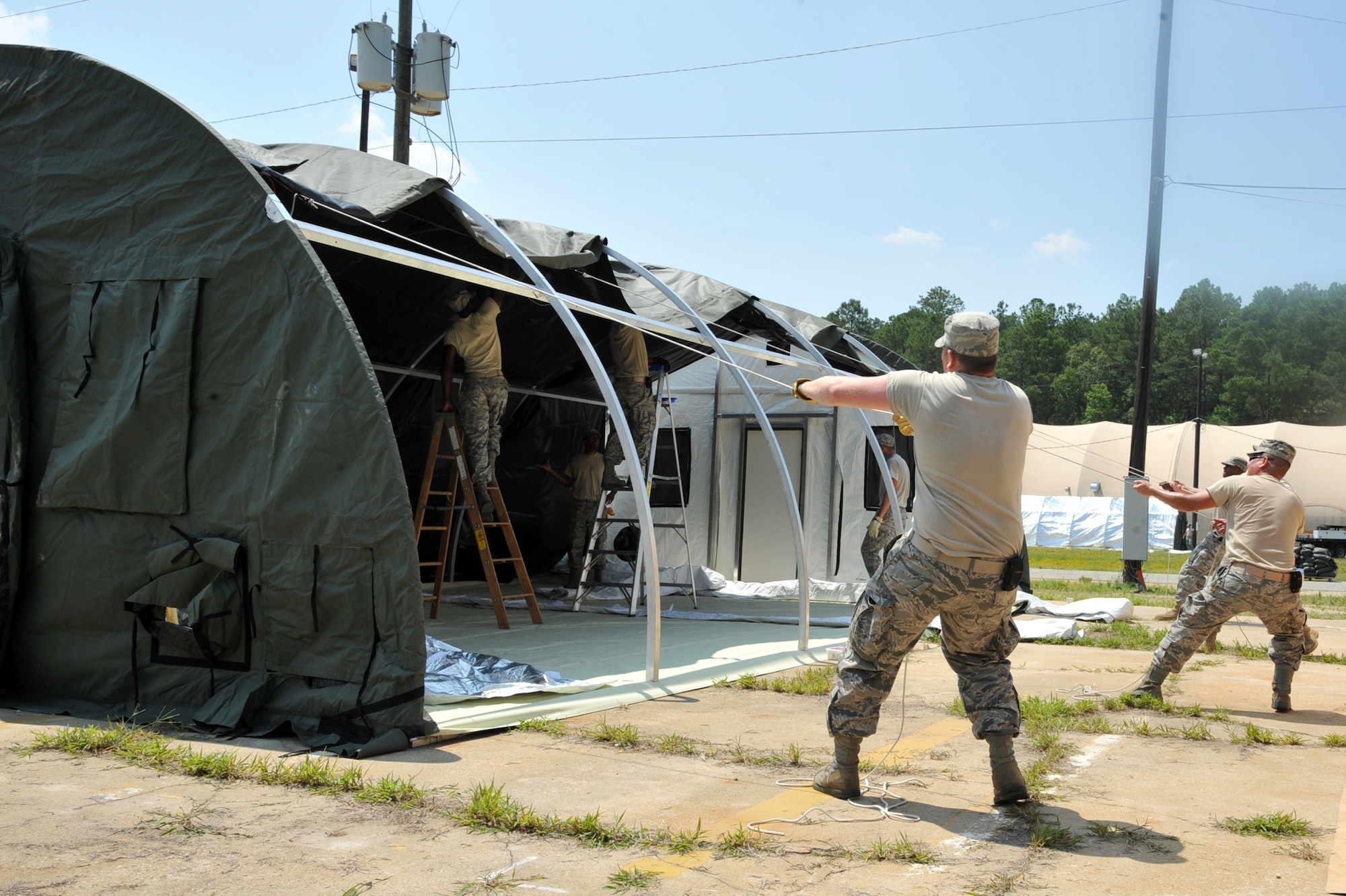 SEYMOUR JOHNSON AIR FORCE BASE - Airmen from across the base set up a rapid deployment system tent here July 11, 2011. Several tents are being used for the upcoming operational readiness exercise (ORE). (U.S. Air Force photo by Senior Airman Whitney Lambert/ Released)
