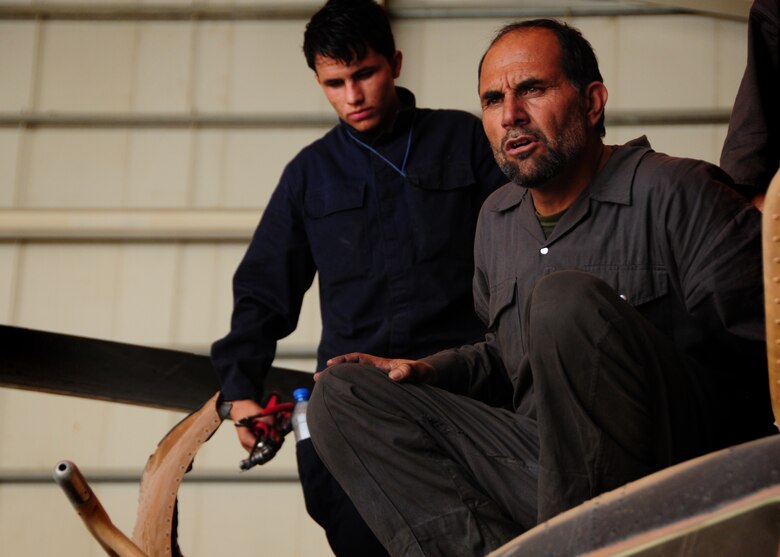 Afghan Air Force maintainers 1st Lt. Saida Jan (front) and Sergeant Mustafa, perform a 300-hour inspection on a Mi-17 V1 helicopter at the AAF compound in Kabul, Afghanistan.  Coalition advisers work daily at the AAF compound to instruct Afghan maintainers on the fine art of maintaining the Afghan Mi-17 and Mi-35 helicopters.  (U.S. Air Force photo by Senior Airmen Amber Williams)     