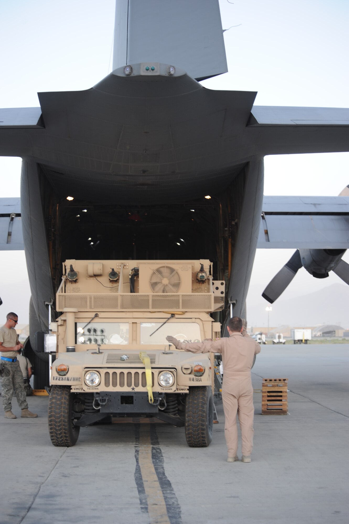 Loadmasters from the 774th Expeditionary Airlift Squadron load a vehicle and supplies at Bagram Airfield, Afghanistan here prior to an afternoon mission to Forward Operating Base Sharana, Afghanistan July 19, 2011. C-130s perform a variety of missions here including strategic airlift, aeromedical evacuation and personnel transport. (U.S. Air Force photo/Capt. Korry Leverett)