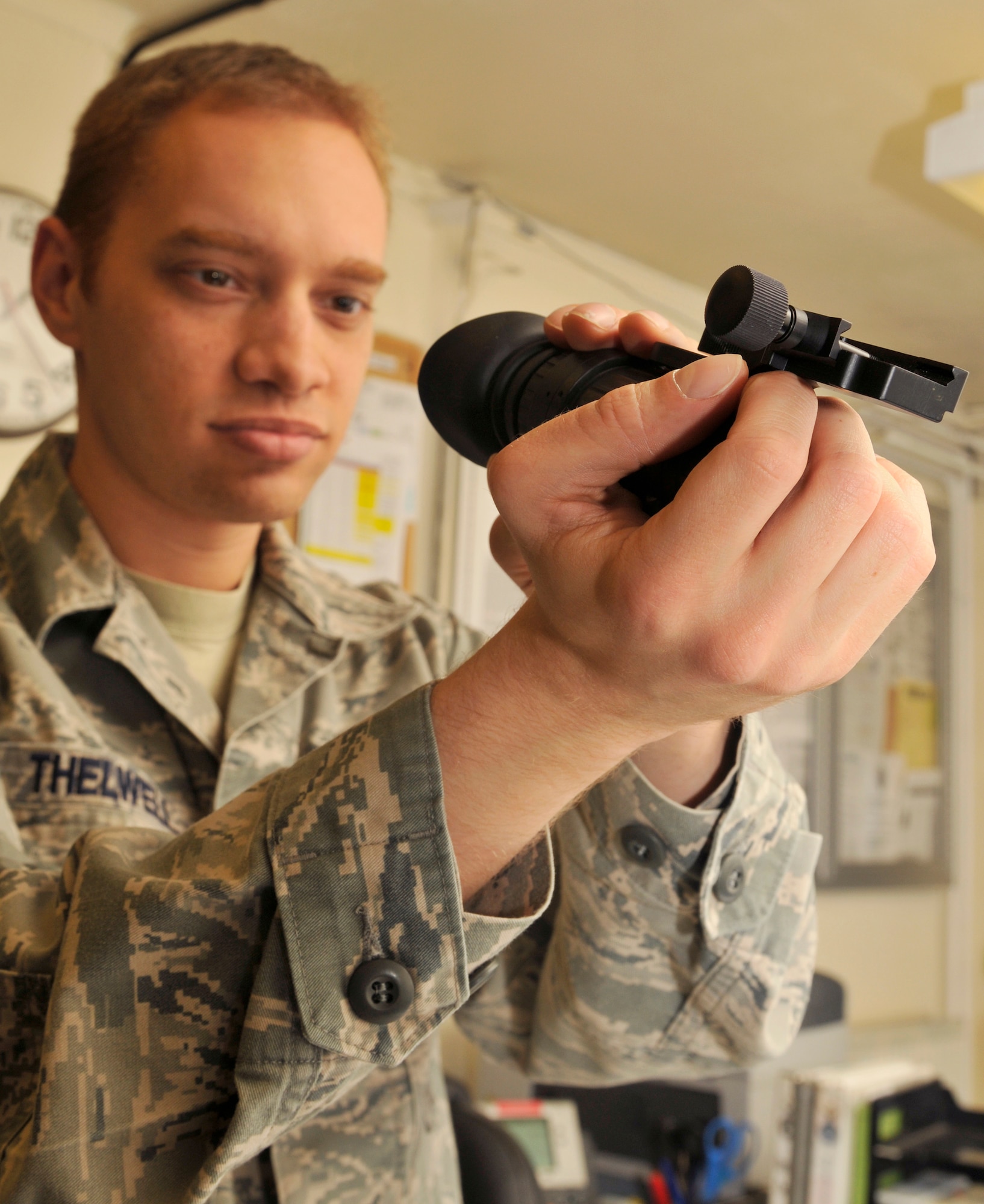 ROYAL AIR FORCE LAKENHEATH, England - Senior Airman Alex Thelwell, 48th Security Forces Squadron armorer, inspects PVS 14 night vision monocular for serviceability at the Armory, July 12, 2011. Armorers are responsible for the distribution of weapons to 48th SFS Airmen on patrol as well as deployers. The 48th SFS is the highest deployed SFS in United States Air Forces in Europe.. (U.S. Air Force photo/Senior Airman Tiffany M. Deuel)