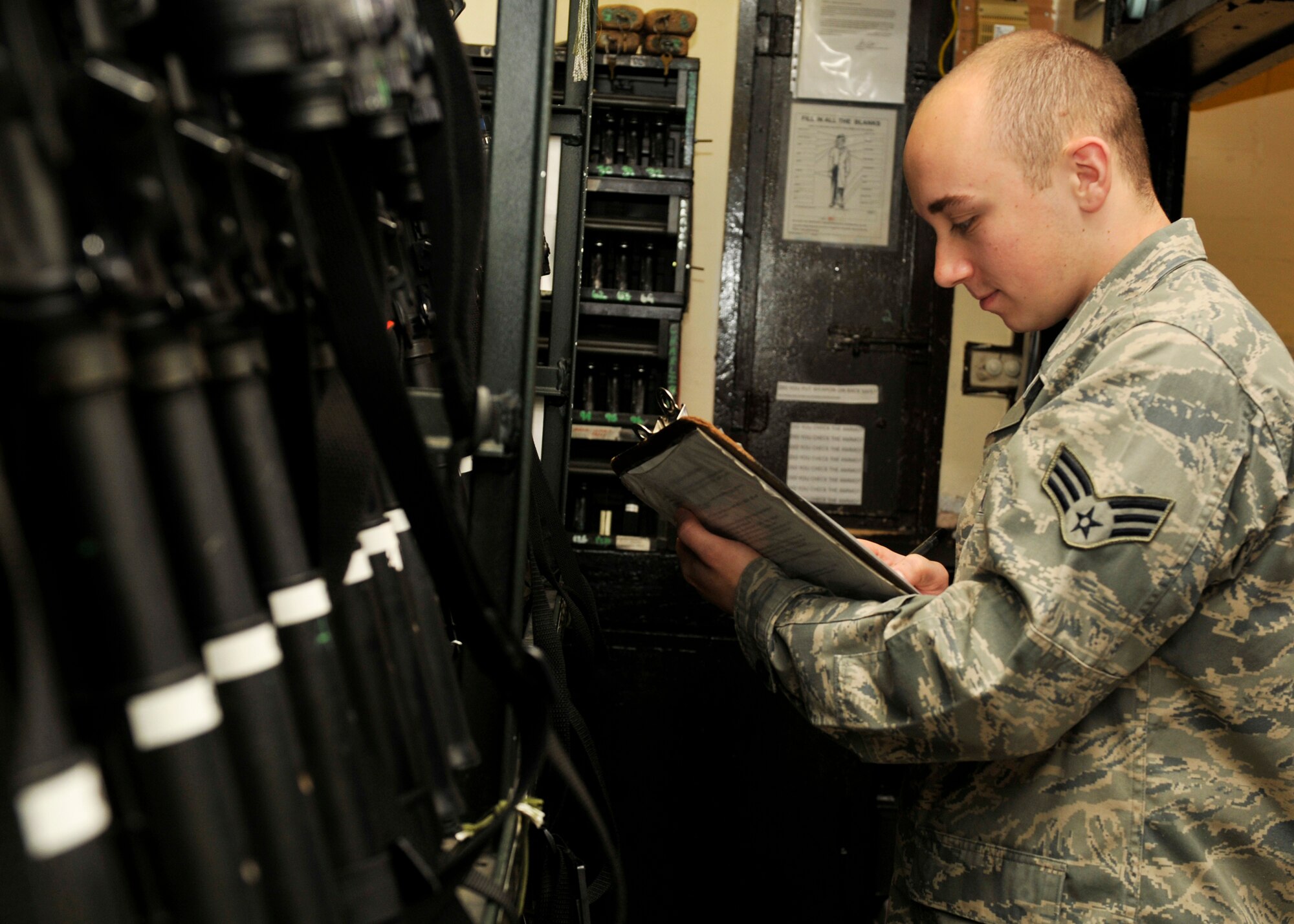 ROYAL AIR FORCE LAKENHEATH, England - Senior Airman Cody Jorsch, 48th Security Forces Squadron armorer, checks weapon inventory using Air Force Form 1473, a weapon accountability log, at the Armory, July 12, 2011. Armorers are responsible for the distribution of weapons to 48th SFS Airmen on patrol as well as deployers. The 48th SFS is the highest deployed SFS in United States Air Forces in Europe.. (U.S. Air Force photo/Senior Airman Tiffany M. Deuel)