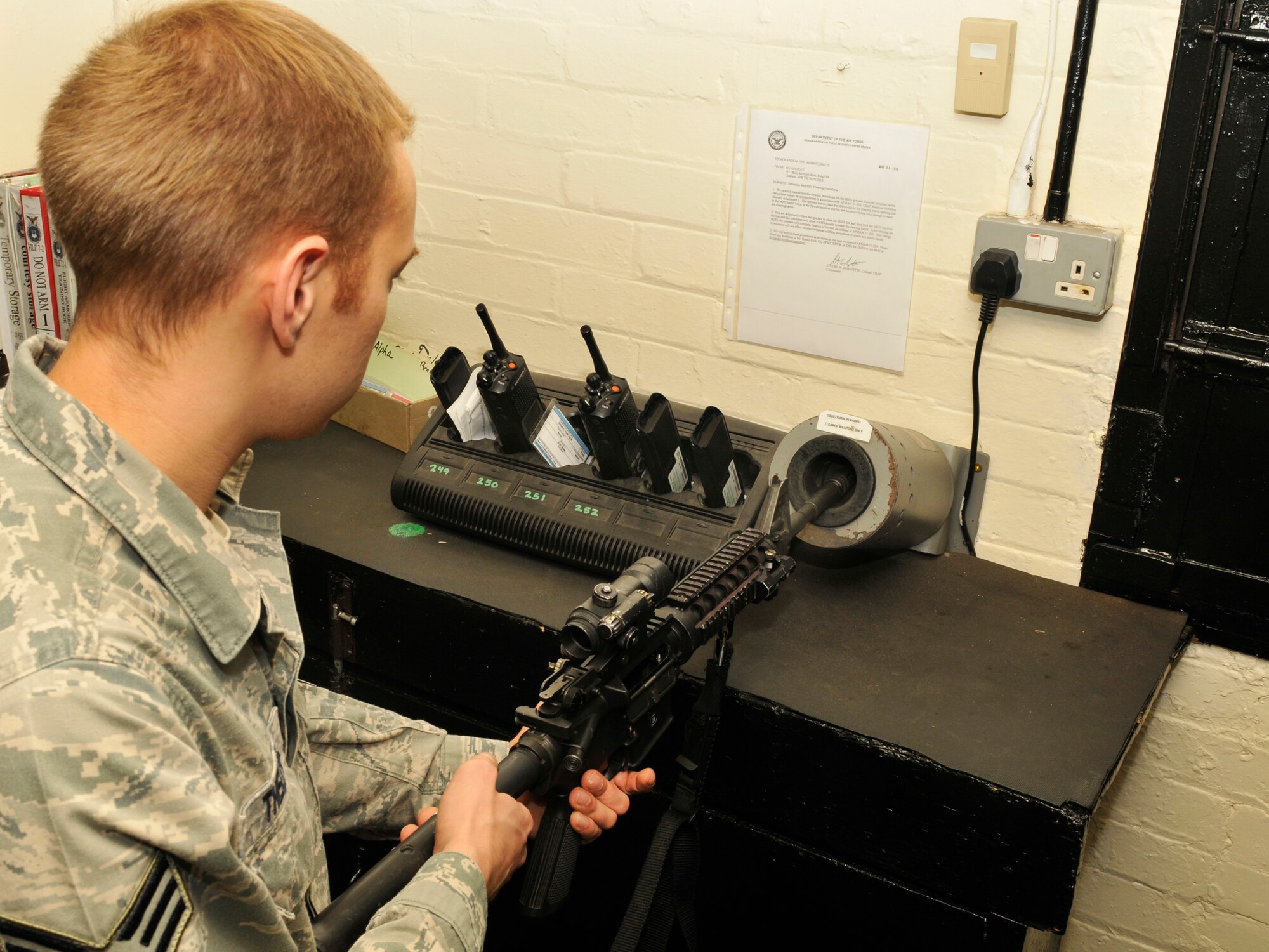 ROYAL AIR FORCE LAKENHEATH, England - Senior Airman Alex Thelwell, 48th Security Forces Squadron armorer, clears an M4 carbine rifle at the Armory, July 12, 2011. Armorers are responsible for the distribution of weapons to 48th SFS Airmen on patrol as well as deployers. The 48th SFS is the highest deployed SFS in United States Air Forces in Europe.. (U.S. Air Force photo/Senior Airman Tiffany M. Deuel)