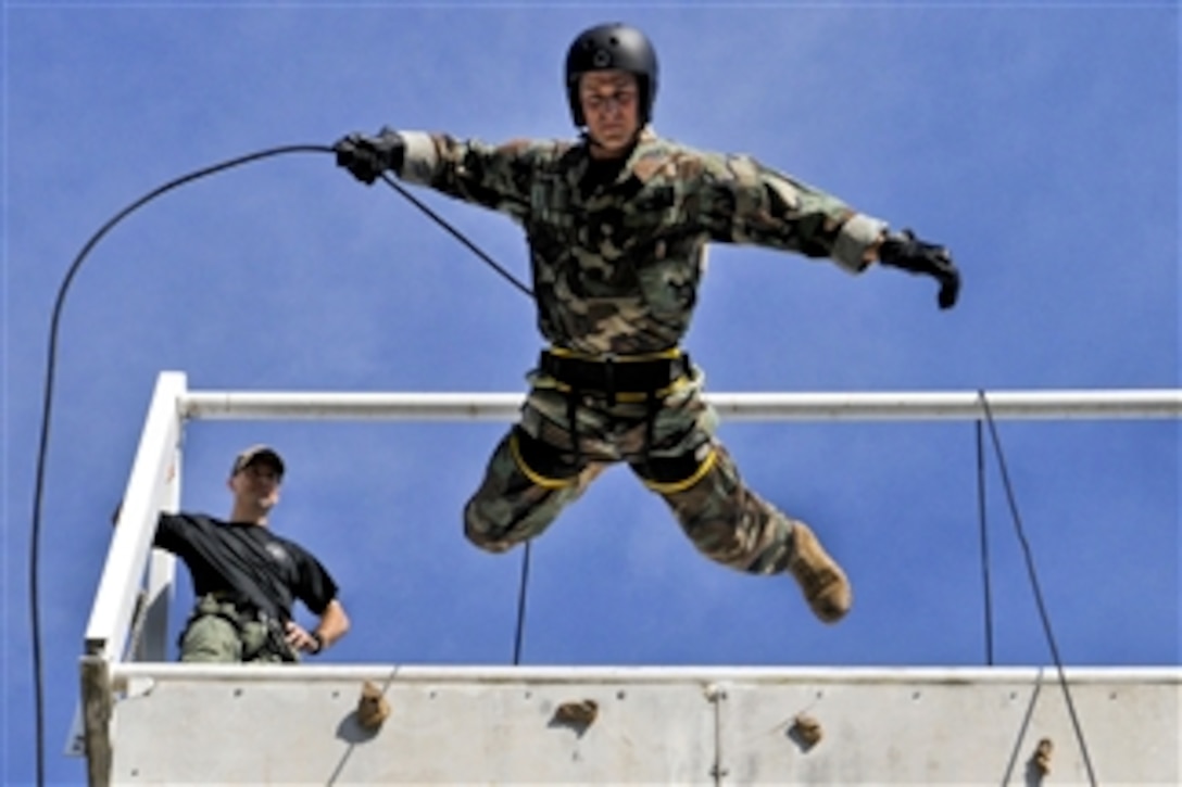 U.S. Navy Lt. Ryan Ramsden rappels off a tower while training with members of the Australian Northern Territory Tactical Response Group during exercise Talisman Sabre 2011 in Darwin, Australia, on July 20, 2011.  Talisman Sabre is a bilateral exercise to train Australian and U.S. forces in planning and conducting combined operations.  Ramsden is assigned to Explosive Ordnance Disposal Mobile Unit 5.  