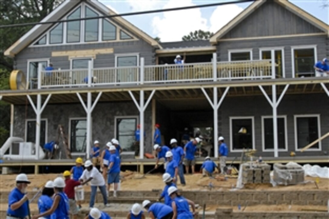 Volunteers race to finish a new home for Navy veteran Barbara Marshall in Fayetteville, N.C., July 20, 2011. The new home and Marshall, who houses and aids homeless female veterans, will be featured in an upcoming episode of "Extreme Makeover: Home Edition." 