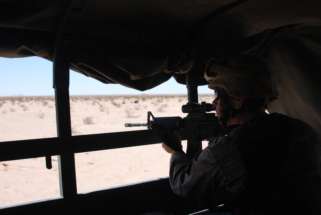 Lance Cpl. Timothy Jackson, a motor transportation operator with Detachment A, Marine Wing Support Squadron 471, Marine Wing Support Group 47, 4th Marine Aircraft Wing, raises his weapon while taking part in a convoy live fire training exercise Thursday, July 21 at a range and proving ground near Marine Corps Air Station Yuma, Ariz. This training evolution is part of exercise Javelin Thrust 2011, and the Marines are part of the Air-Combat Element of the exercise.
