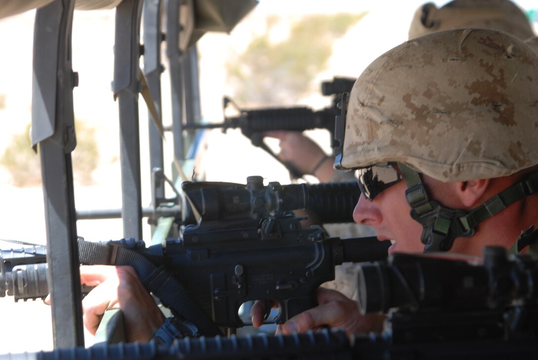 Sgt. John Umlauf a motor transportation operator with Detachment A, Marine Wing Support Squadron 471, Marine Wing Support Group 47, 4th Marine Aircraft Wing, engages targets during a realistic convoy training scenario Thursday, July 21 at a range and proving ground near Marine Corps Air Station Yuma, Ariz. This training scenario prepares Marines for combat deployments and teaches them to engage enemy targets while mobile.