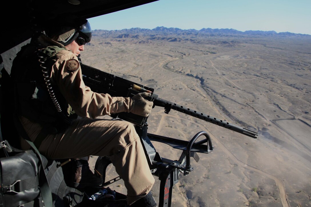 Staff Sgt. Matthew A. Ratliff, HMLA-773 aerial observer, fires an M2 .50-caliber machine gun out of a UH-1N Huey helicopter during Operation Javelin Thrust July 21. The exercise allowed reserve Marines to keep current in their training as well as prepare for a deployed environment.