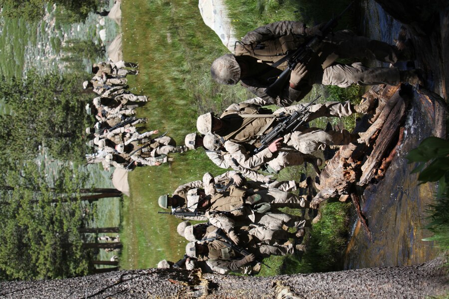 Marines with Company K, 3rd Battalion, 23rd Marine Regiment, cross a stream on their way to their first point during a land navigation course as part of Operation Javelin Thrust, July 21.
