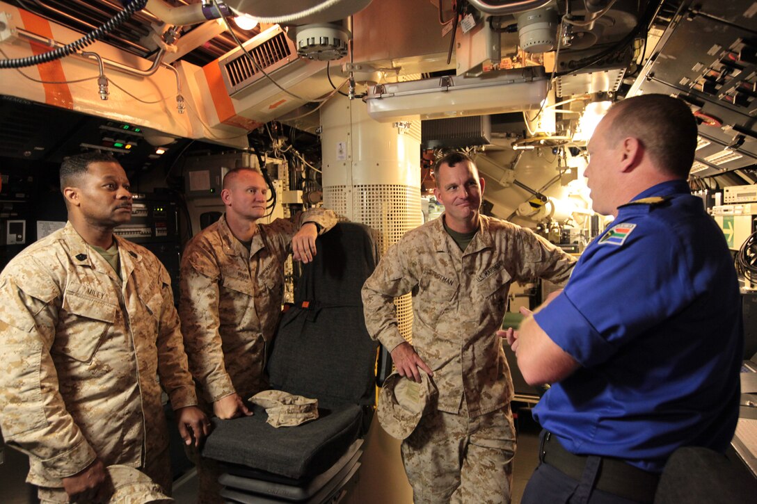 Exercise Shared Accord 2011 task force leadership listens as South African Navy Commander Darren White, commander of the SAS Charlotte Maxeke a diesel-powered, heroine class submarine, explains the vessel’s capabilities and uses July 21. SA 2011 is a bilateral military training and humanitarian mission held annually throughout Africa.
