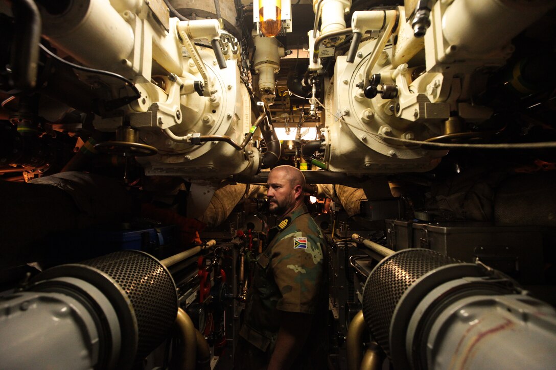 South African Navy Capt. Doric Swart stands in the engine room of the SAS Charlotte Maxeke diesel-powered, heroine class submarine during a tour held for Exercise Shared Accord 2011 task force leadership July 21. SA 2011 is a bilateral military training and humanitarian mission held annual throughout Africa.