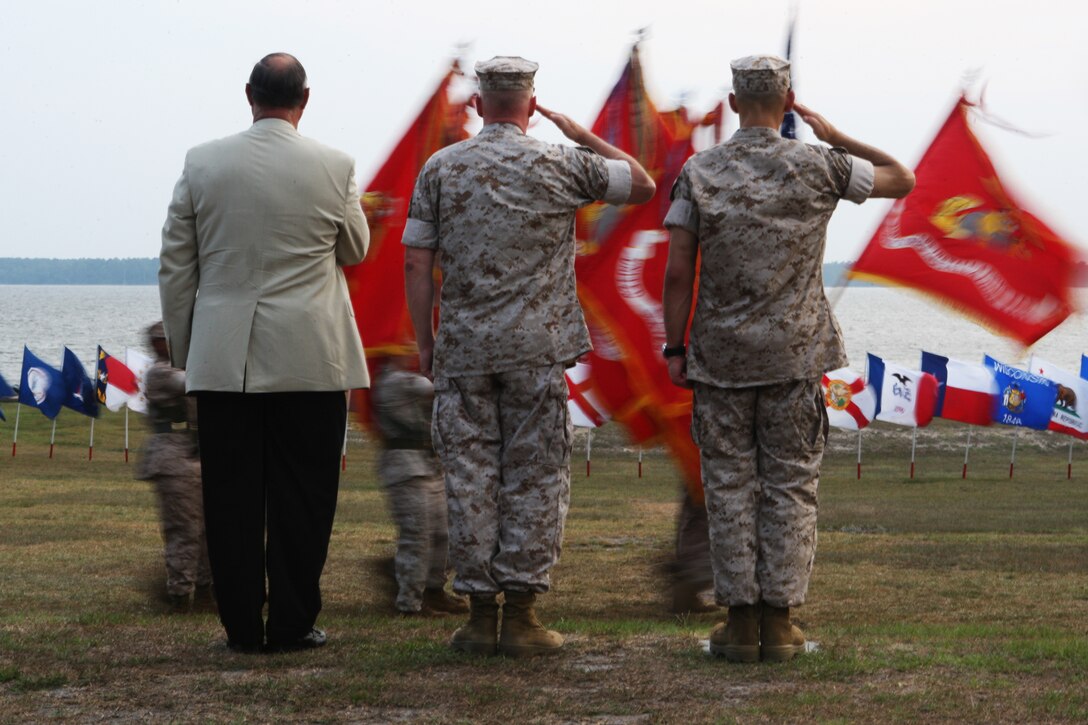 (From left to right) Retired Maj. Gen. Robert C. Dickerson, first commanding general of Marine Corps Installations East; Maj. Gen. Carl B. Jensen, outgoing commanding general of MCIEAST and Col. Thomas A. Gorry, brigadier general select, incoming commander of MCIEAST, stand during a pass and review of troops following the MCIEAST change of command ceremony and Jensen’s retirement at the 2nd Marine Logistics Group Amphitheater, July 22.