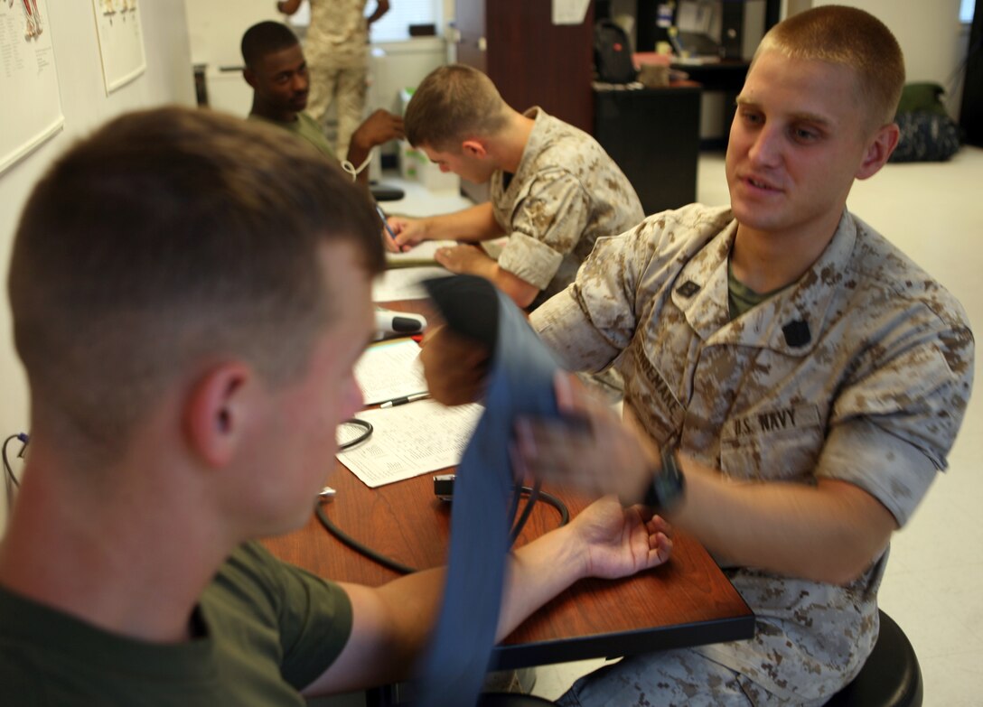 Seaman Joshua Shoemake, a hospital corpsman with Headquarters Battalion, 2nd Marine Division, finishes taking a Marine’s blood pressure at the Headquarters Battalion Aid Station aboard Marine Corps Base Camp Lejeune, N.C. July 22, 2011. The 24-year-old Shoemake hopes to use the experience he is gaining at the BAS and apply it in theater during a potential deployment to Afghanistan.