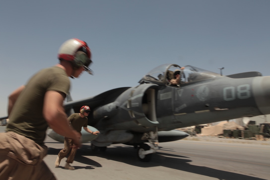 Marine Attack Squadron 513 ordnance technicians Cpl. Timothy Johnson, left, a Huntsville, Texas, native, and Cpl. David Ryan, a San Jose, Calif., native, arm one of the squadron’s AV-8B Harriers for a combat mission on the flightline of Kandahar Airfield, Afghanistan, July 22.