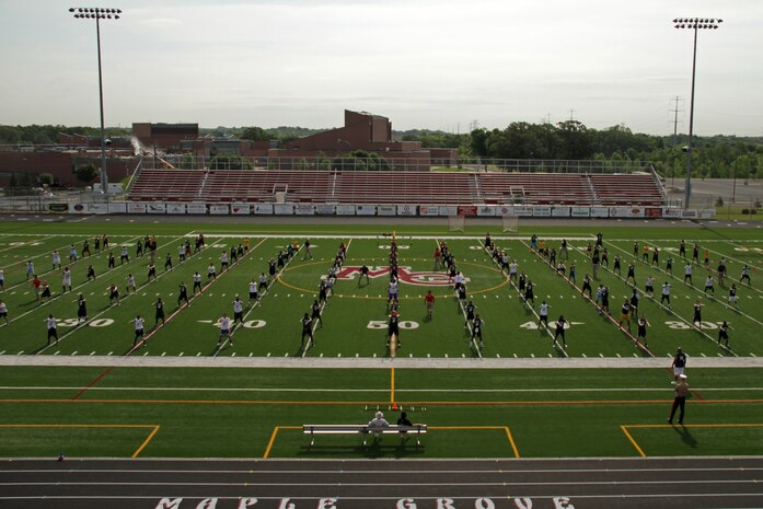 Drill instructors and Marines with Recruiting Station Twin Cities lead more than 130 athletes in warm-up exercises at Maple Grove Senior High School during the Minneapolis Junior Rank Diamond Flight Football Camp July 22. For additional imagery from the event, visit www.facebook.com/rstwincities.