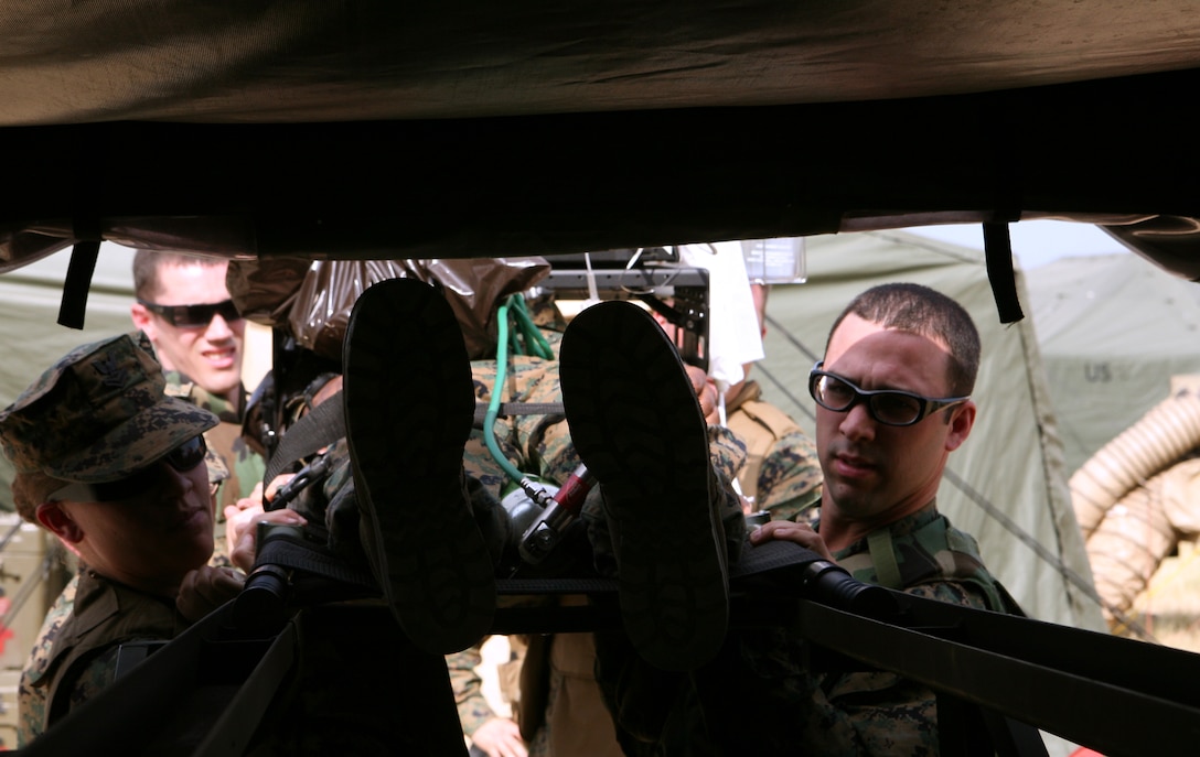 During a simulated casualty drill, Petty Officer 2nd Class Bridget J. Shanahan, a Los Angeles, Calif., native, and Petty Officer 3rd Class Anthony M. Tiner, Pittsburgh, Penn., native, both hospital corpsman, 4th Medical Battalion, slide a patient on a stretcher into their ambulance. The 4th Medical Battalion set up a Forward Resuscitative Surgical Suite during Exercise Agile Spirit 2011 to support the 350 U.S. Marines and sailors conducting counterinsurgency and peacekeeping operations training with nearly 500 Georgian soldiers from the Georgian 4th Infantry Brigade in Vaziani Training Area, outside of Tblisi.