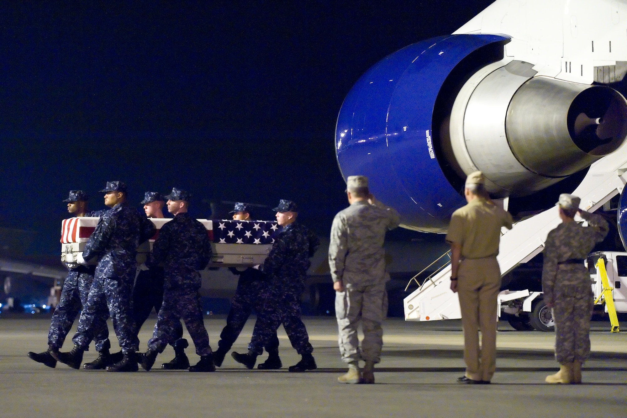 A U.S. Navy carry team transfers the remains of Navy Petty Officer 1st Class Stacy O. Johnson, of Rolling Fork, Miss., at Dover Air Force Base, Del., July 22, 2011. (U.S. Air Force photo/Roland Balik)