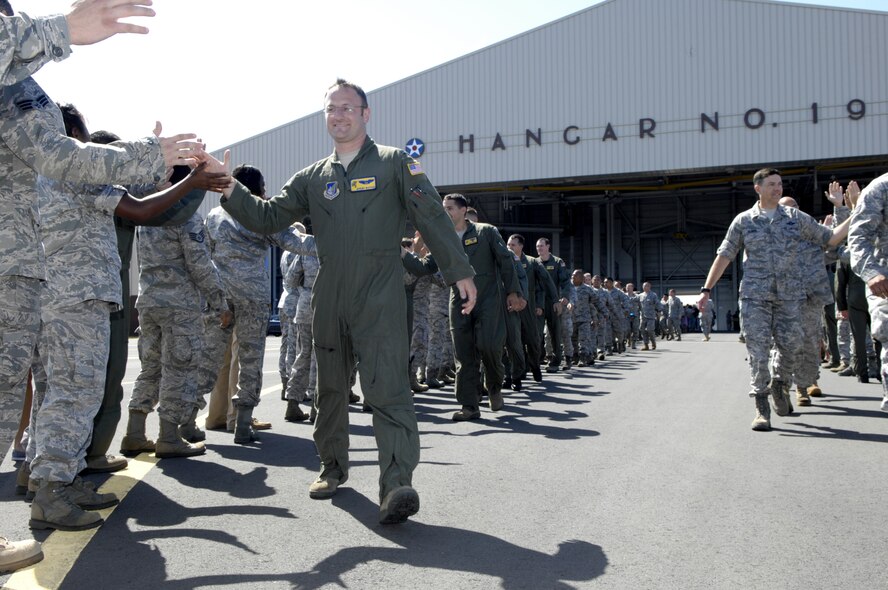 Capt. Jeremy Buxton, high-fives some other Wing Airmen July 22 as he departs Joint Base Pearl Harbor-Hickam, Hawaii. Buxton and the Team Hickam Rodeo 2011 Team will travel to Joint Base Lewis-McChord, Wash., for Air Mobility Rodeo 2011. This competition focuses on improving worldwide air mobility forces' professional core abilities. (U.S. Air Force Photo/David D. Underwood, Jr.)