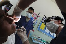 Delgerkhaan, Mongolia – U.S. Air Force Staff Sgt. Jose Cardenas, a native of Hildalgo, Texas and currently assigned to the 8th Medical Group, Kunsan Air Base, Republic of Korea watches as Major (Dr.) Rebecca Neitzke, a native of Grand Rapids Minn., and currently assigned to Kunsan AB, ROK numbs a Mongolian patient's mouth before pulling his infected tooth while at the two-day multinational mobile clinic in Delgerkhaan, Mongolia on July 20 in support of Pacific Angel-Mongolia, a 13th Air Force led combined humanitarian assistance operation. U.S. Soldiers, Sailors and Airmen worked together with Mongolian Armed Forces, Sri Lankan Forces and National Government Organization Project Hope in providing healthcare in Delgerkhaan for two days. Their team moves to a new location every two days to spread out their coverage in the area, while a stationary team works out of a hospital in Ondorkhan, Mongolia. This is the fourth year of Pacific Angel, but the first time the operation has been hosted in Mongolia. The operation helps cultivate common bonds and foster goodwill between the United States, Mongolia and other regional nations. In addition to veterinary training, a clinic is being refurbished and medical outreach events are being held in Ondorkhan, Delgerkhaan and Tsenkhermandal soums of the Hentii province from July 18-23.  (U.S. Air Force photo/Master Sgt. Cohen A. Young)
