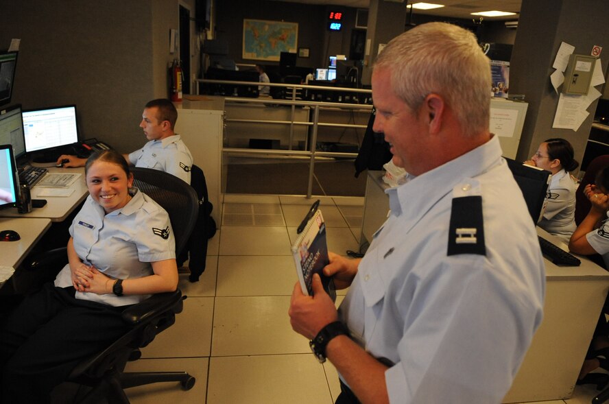 Chaplain (Capt.) Richard Holmes, a member of the 2nd Bomb Wing Chaplain Corps, visits with Airman 1st Class Amanda Yeakley, 26th Operational Weather Squadron, on Barksdale Air Force Base, La., July 18. Chaplain Holmes is the tenant chaplain for the 2nd Maintenance Group and 2nd Operations Group, and he routinely makes rounds to visit with Airmen to boost morale and inform them of his open door policy. (U.S. Air Force photo Airman 1st Class Micaiah Anthony)(RELEASED)  