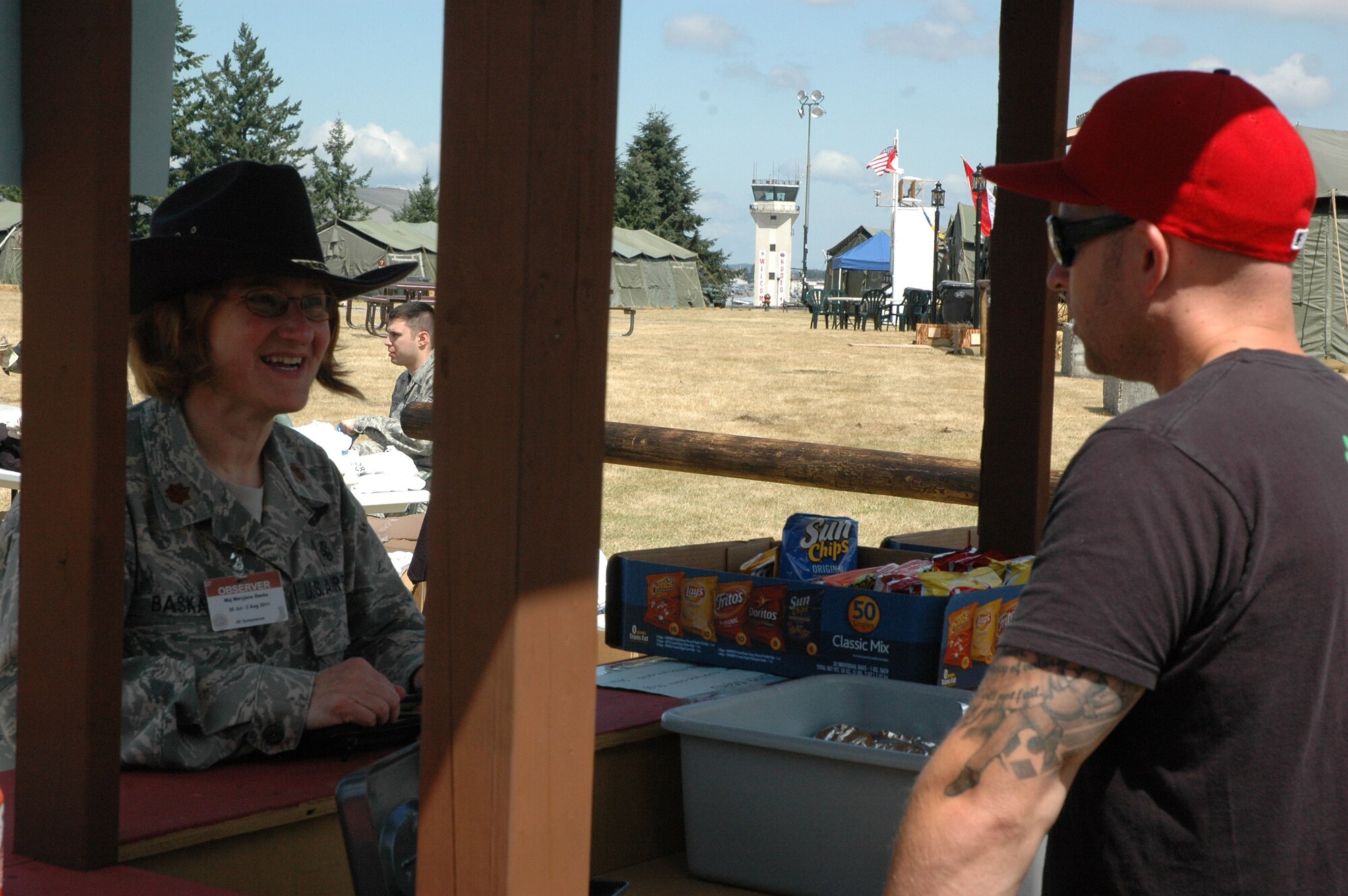 Maj. MaryJane Baska, 446th Aeromedical Evacuation Squadron, McChord Field, Wash., stops by the 446th Airlift Wing's tent at Rainier Ranch for some lunch, served up by Stafff Sgt. Andrew Thatcher, 728th Airlift Squadron. (U.S. Air Force photo by Sandra Pishner)