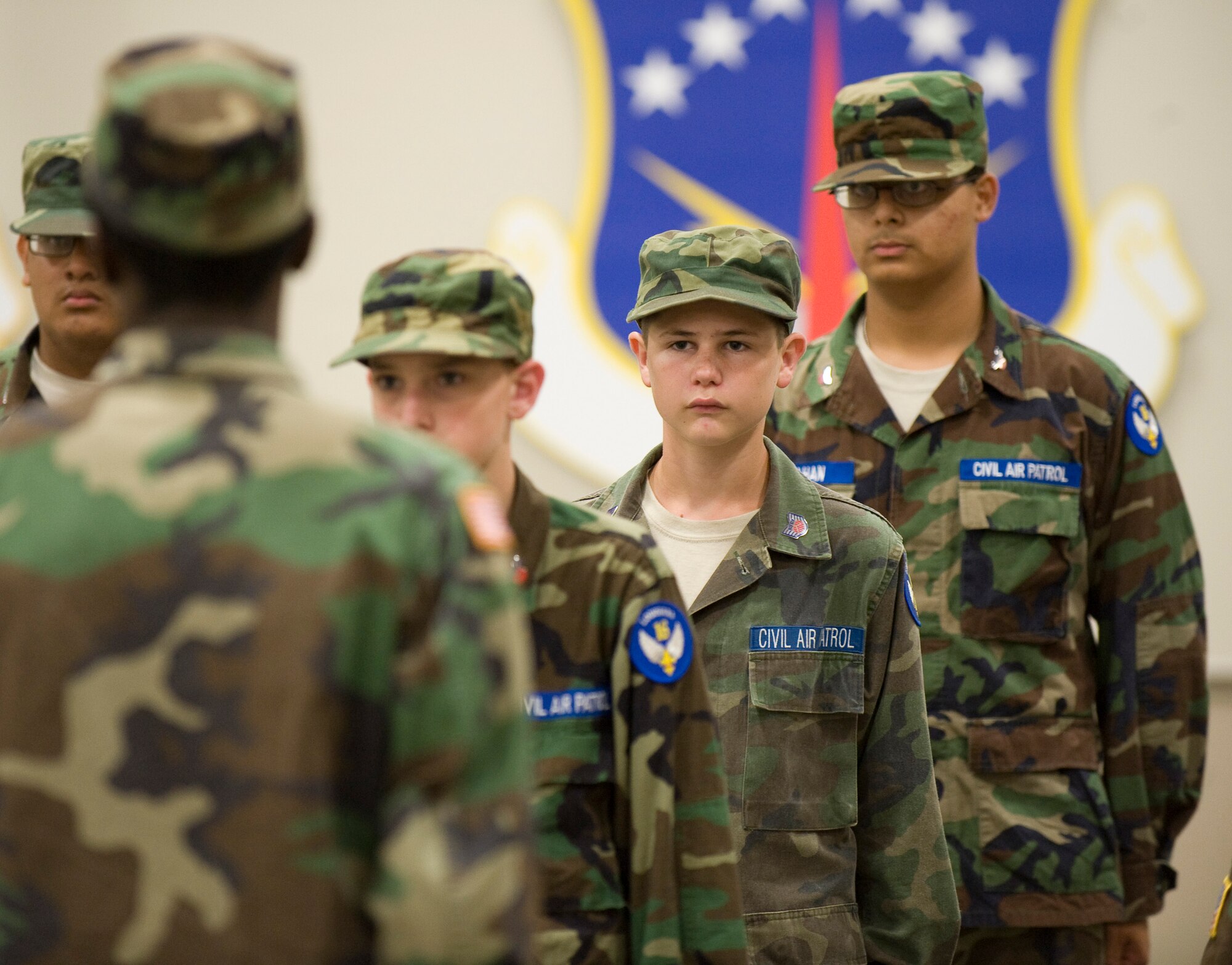 Cadets with the Louisiana Civil Air Patrol Cadet Encampment stand at attention during a drill competition in Hoban Hall on Barksdale Air Force Base, La., July 22. The cadets competed against each other, completing a series of drill movements judged by members of the base honor guard.  (U.S. Air Force photo/Senior Airman Chad Warren) (RELEASED)