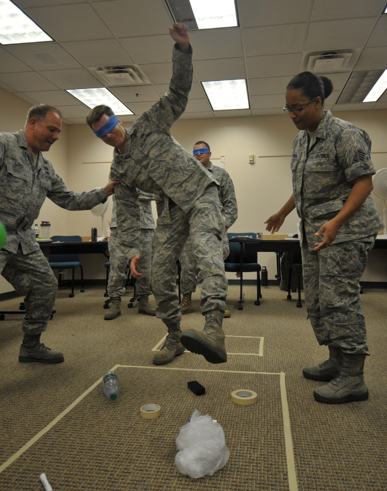Tech. Sgt. Thomas Lord, a leadership facilitator from the 507th Medical Squadron at Tinker AFB, Oklah. prevents Tech. Sgt. Geof Begey 931st AMXS, from falling as he attempts to navigate a series of items under oral directions provided by Tech. Sgt. Cecelia Matthews, 931st FSS during the NCO Leadership Development Course at McConnell AFB. Tech. Sgt. Lord travels around the country teaching leadership to NCOs for Air Force Reserve Command. (Air Force Photo by Brannen Parrish)