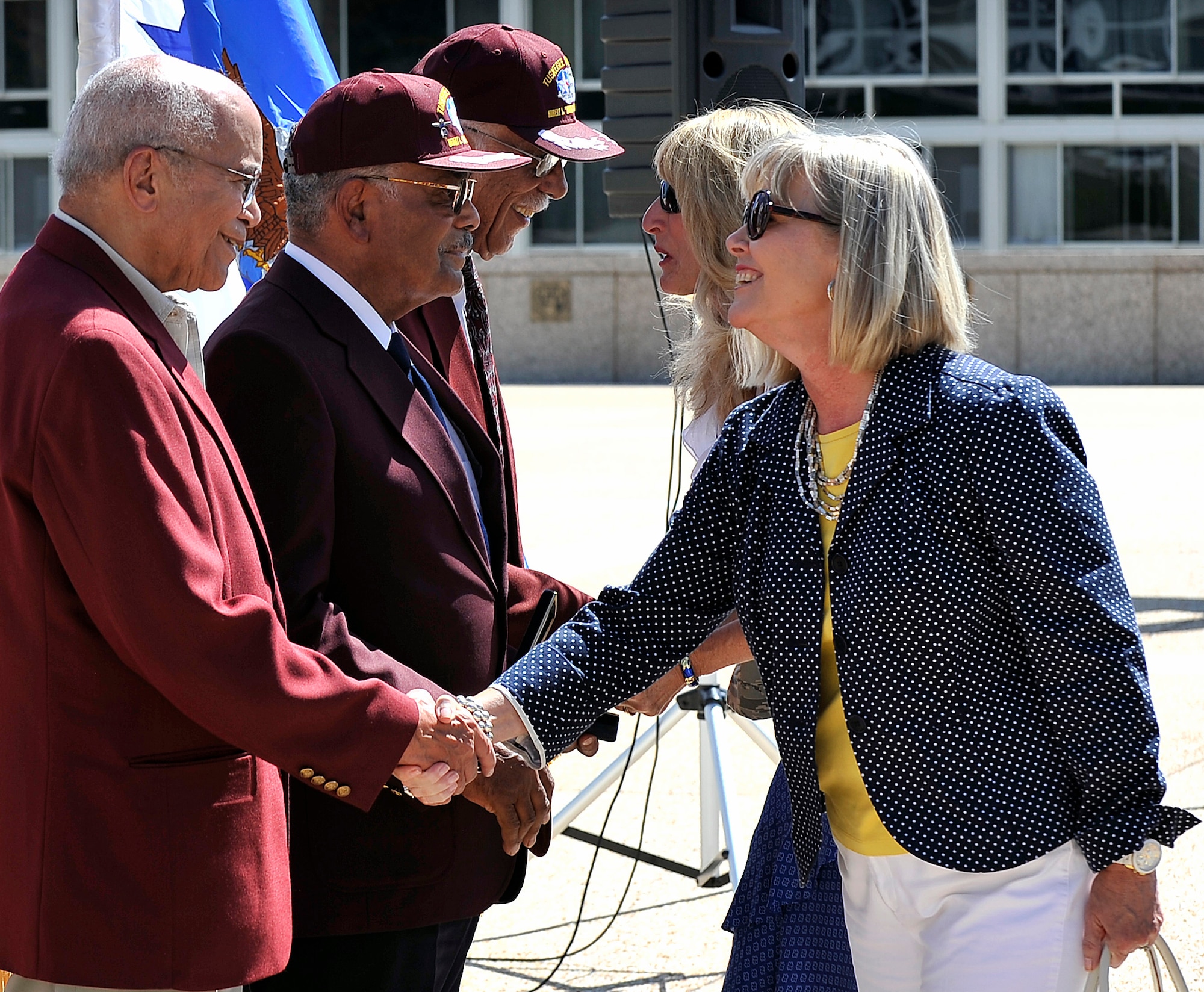 Suzie Schwartz and Paula Gould thank former Aviation Cadet Randy Edwards, former 2nd Lt. Franklin Macon and retired Capt. Sam Hunter, Jr. for their service to the United States during a ceremony at the Air Force Academy July 22, 2011. The Academy hosted the ceremony to present a replacement bronze Tuskegee Airman medal replica to Macon, whose original replica was stolen in a home burglary May 31. Schwartz is the wife of Air Force Chief of Staff Gen. Norton Schwartz, and Gould is the wife of Academy Superintendent Lt. Gen. Mike Gould. (U.S. Air Force photo/Ray McCoy)