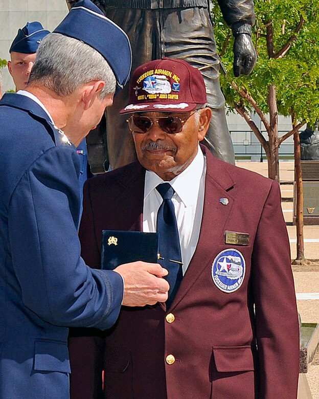 Air Force Chief of Staff Gen. Norton Schwartz presents former 2nd Lt. Franklin Macon with a bronze replica of the Tuskegee Airmen Congressional Gold Medal during a brief ceremony at the Air Force Academy July 22, 2011. Macon's original replica was stolen in a home burglary May 31. Airmen at Peterson Air Force Base and the Air Force Academy worked together to procure the new medal. (U.S. Air Force photo/Ray McCoy)