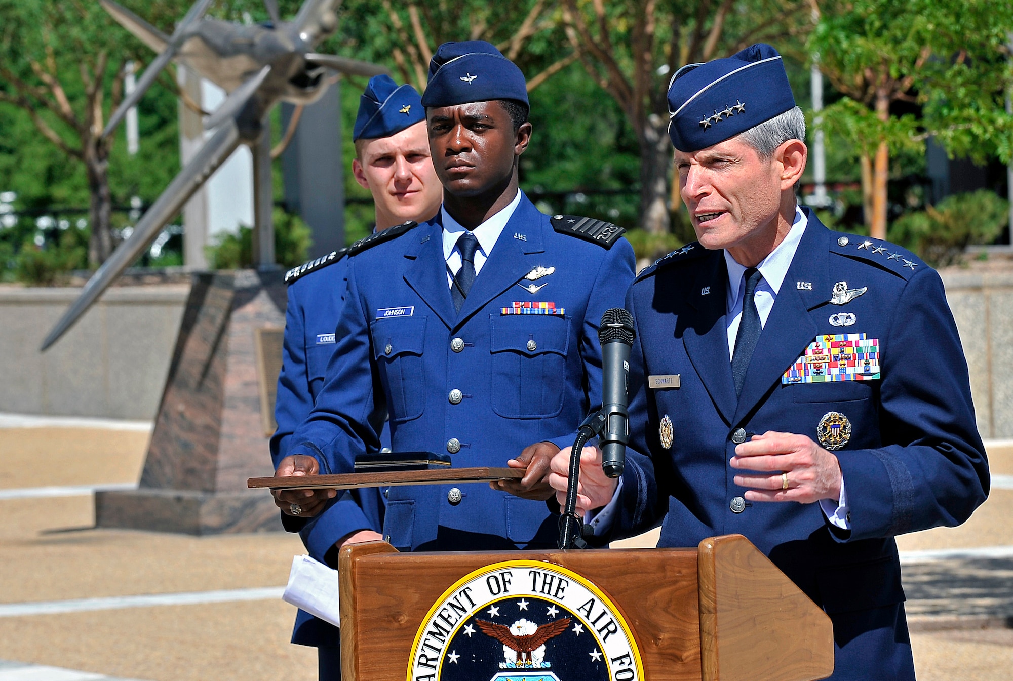 Air Force Chief of Staff Gen. Norton Schwartz, right, speaks at a ceremony to present a replacement Tuskegee Airmen medal replica to former 2nd Lt. Franklin Macon at the Air Force Academy July 22, 2011. Macon, one of the original Tuskegee Airmen, lost his medal replica in a home burglary May 31. Cadet 1st Class Frederick Johnson of Cadet Squadron 14, center, served as proffer. Cadet 1st Class Kevin Loudermilk of CS 10, left, was the master of ceremonies. (U.S. Air Force photo/Ray McCoy)