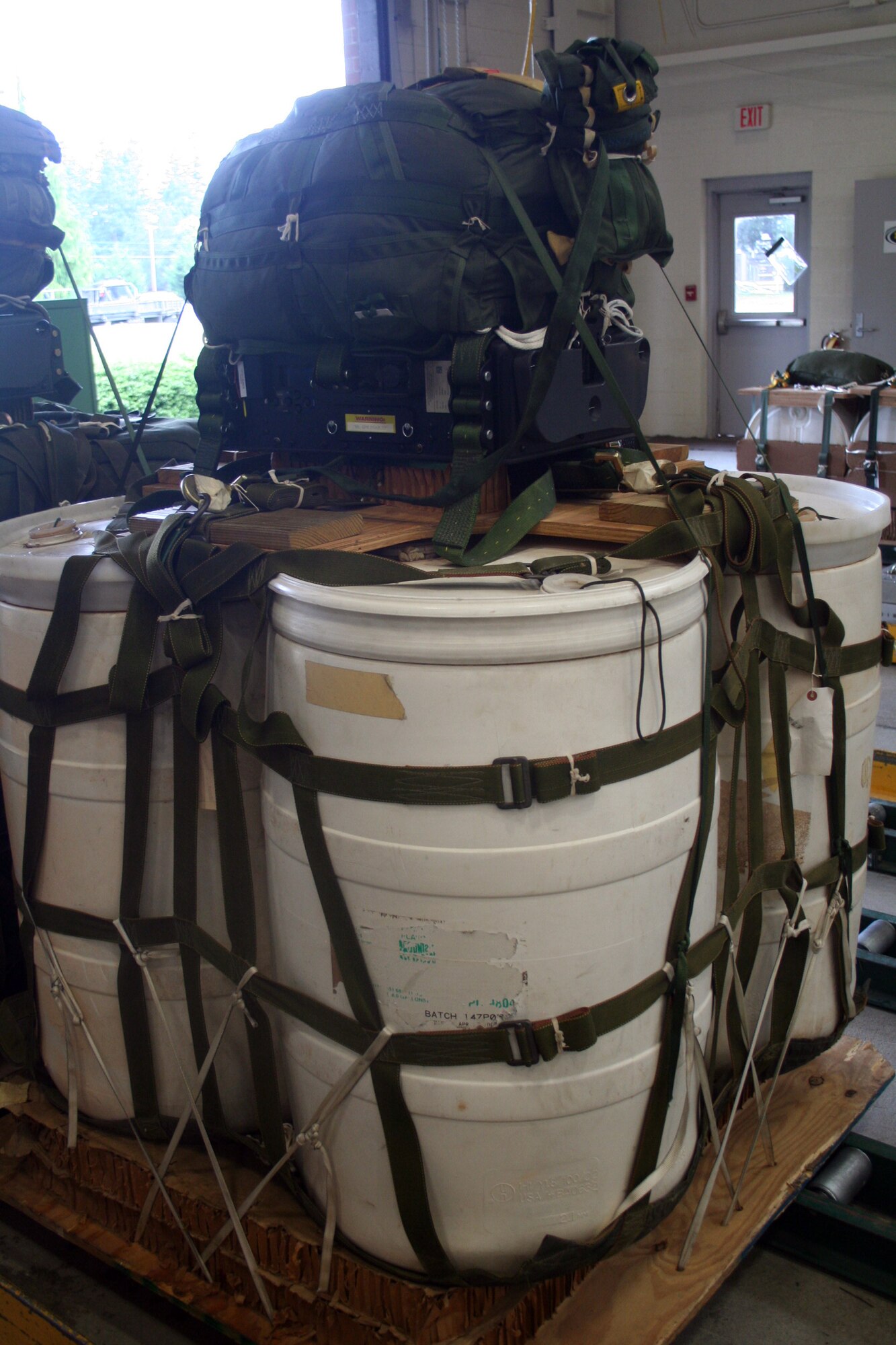 A Joint Precision Aerial Delivery System airdrop bundle is shown in the 62nd Aerial Port Squadron aerial delivery facility July 21, 2011, at Joint Base Lewis-McChord, Wash. Eight people operate the facility and prepare airdrop training bundles for the 62nd Airlift Wing's mission. (U.S. Air Force Photo/Master Sgt. Scott T. Sturkol)