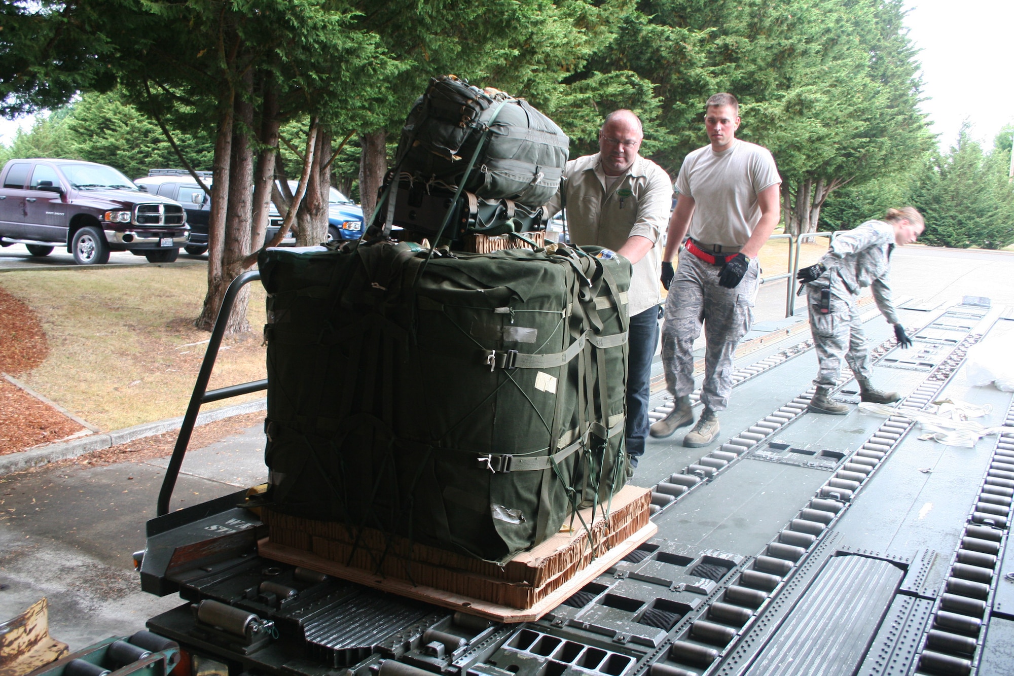 Air transportation Airmen use a loader to drop off an airdrop bundle at the 62nd Aerial Port Squadron aerial delivery facility July 21, 2011, at Joint Base Lewis-McChord, Wash. Eight people operate the facility and prepare airdrop training bundles for the 62nd Airlift Wing's mission. (U.S. Air Force Photo/Master Sgt. Scott T. Sturkol)