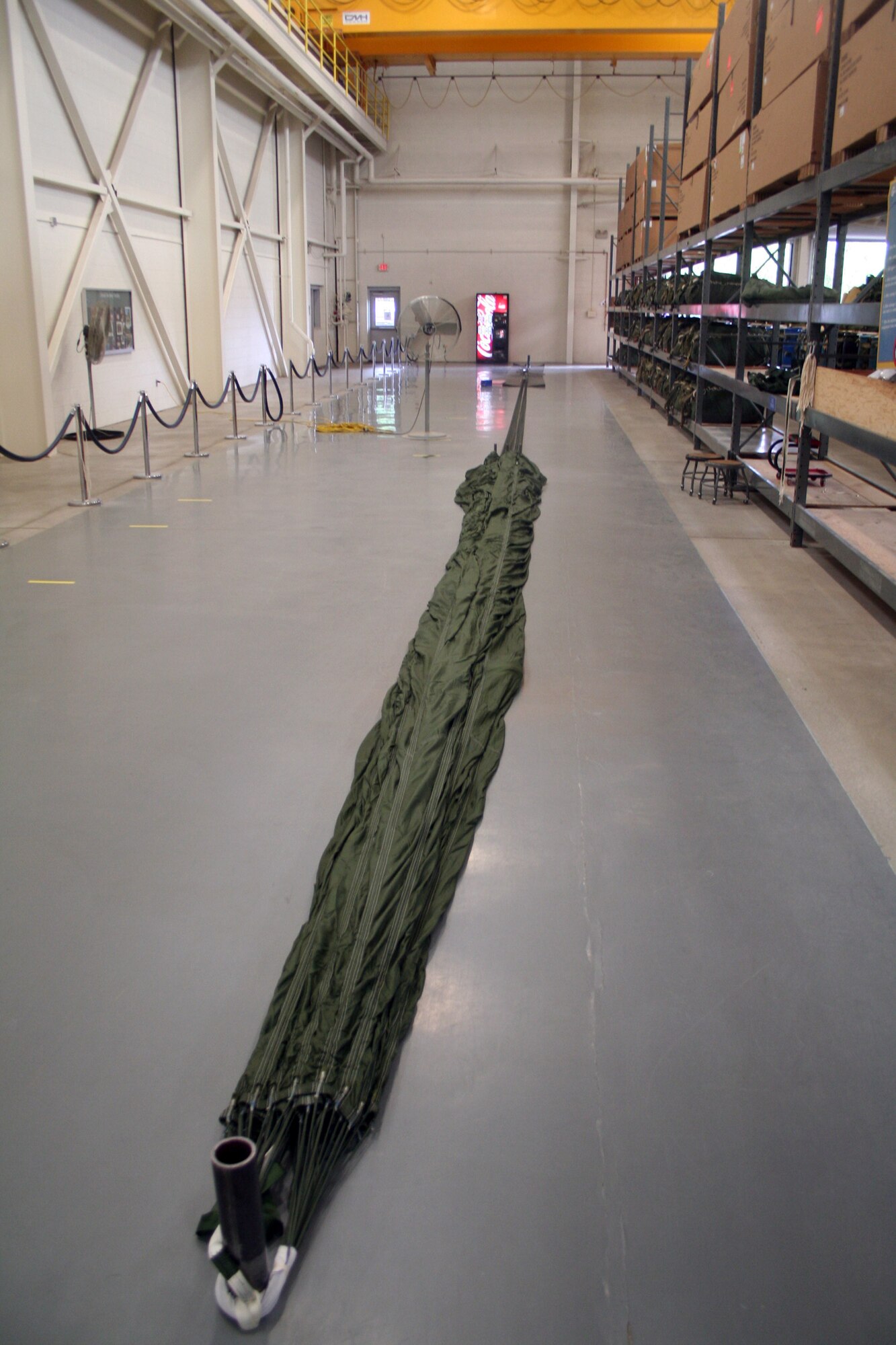 A parachute for an airdrop bundle is shown stretched out nearly 90 feet in the 62nd Aerial Port Squadron aerial delivery facility July 21, 2011, at Joint Base Lewis-McChord, Wash. Eight people operate the facility and prepare airdrop training bundles for the 62nd Airlift Wing's mission. (U.S. Air Force Photo/Master Sgt. Scott T. Sturkol)
