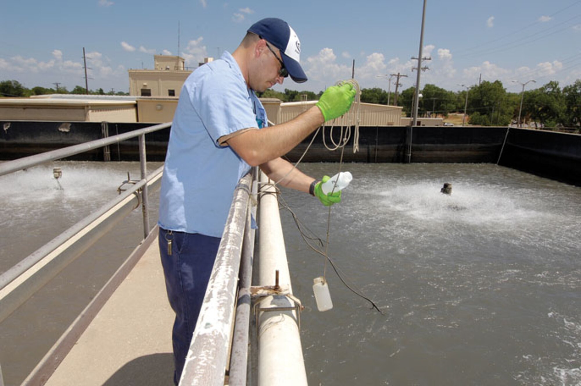 Will Wilson, an Industrial Waste Water Treatment Plant operator with the 72nd Air Base Wing Civil Engineer Directorate, pulls water samples from basins where surface aerators work to reduce organic components. Water is checked several times daily to monitor for any spikes or changes and to check performance of the plant. Waste water flows into the treatment plant from industrial shops across Tinker where it is treated through several cleaning processes that remove contaminates before going to the Oklahoma City system for final treatment.  (Air Force photos by Margo Wright)