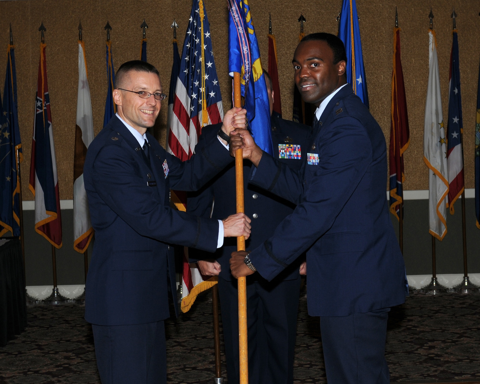 Capt. Clarence Burton, 14th Contraction Squadron commander, takes the 14th CONS guidon from Colonel-select Scott Frickenstein, 14th Mission Support Group commander, during the 14th CONS assumption of command. (U.S. Air Force photo)