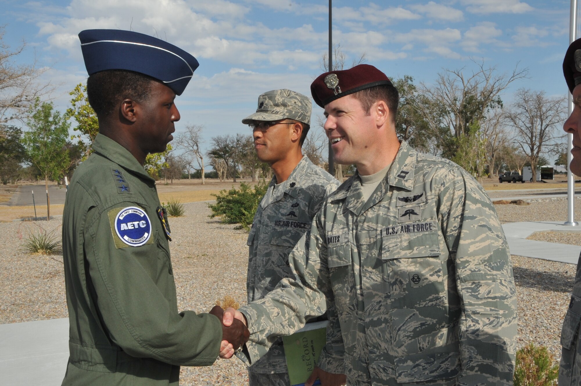 Below, Capt. Luke Bates, 342nd Training Squadron Det 1 commander, right, and Lt. Col. Jerry Kung, 342 TRS commander, greet Gen. Edward A. Rice Jr., AETC commander, during his visit to the Guardian Angel Training Complex.

Photo by Todd Berenger