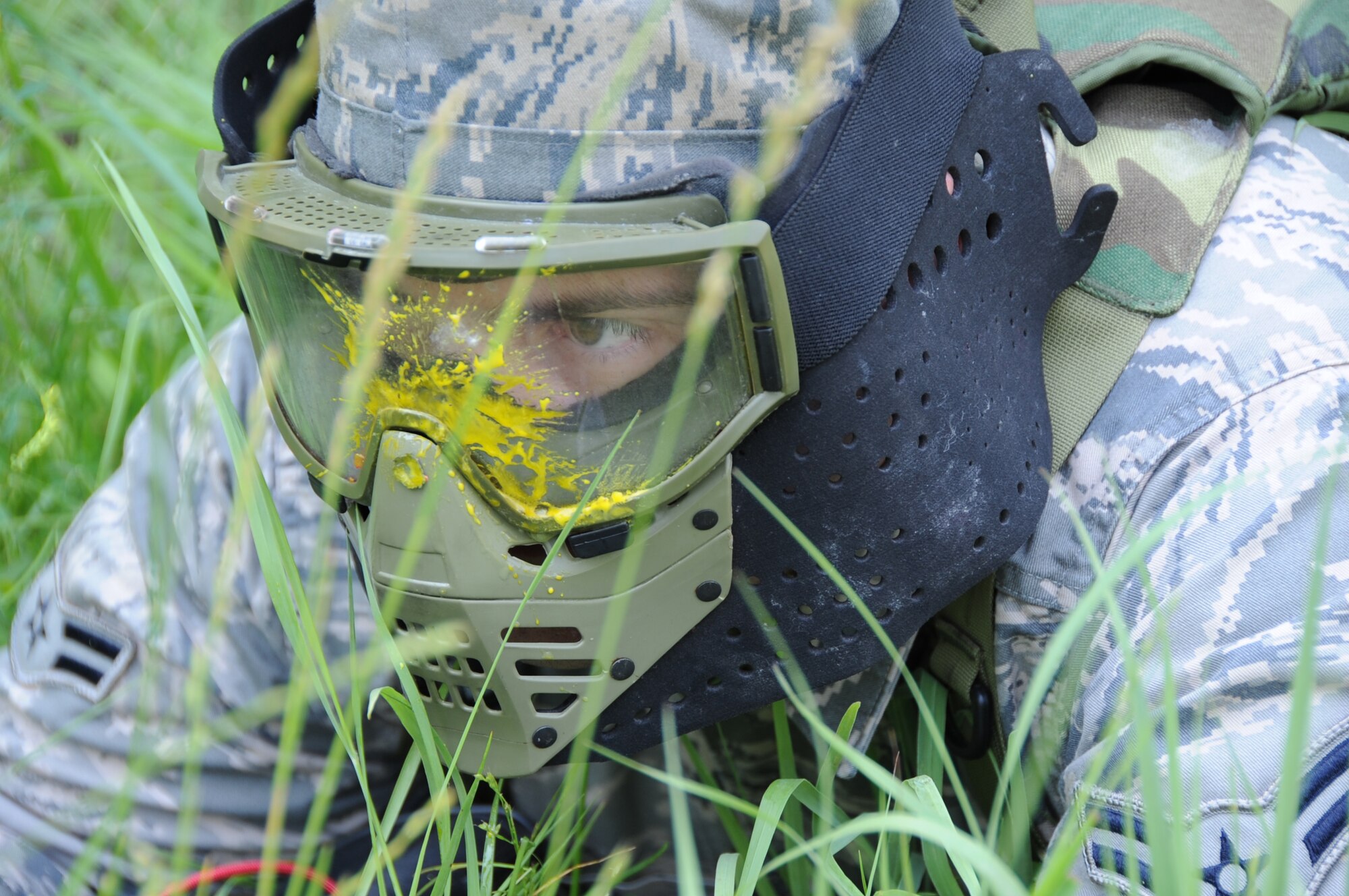 Splattered: Airman 1st Class Taylor Maul, a fire team member, takes a paintball to the face June 8, during a paintball exercise during the 155th Security Forces Squadron’s field training exercise at Camp Ashland, Neb.