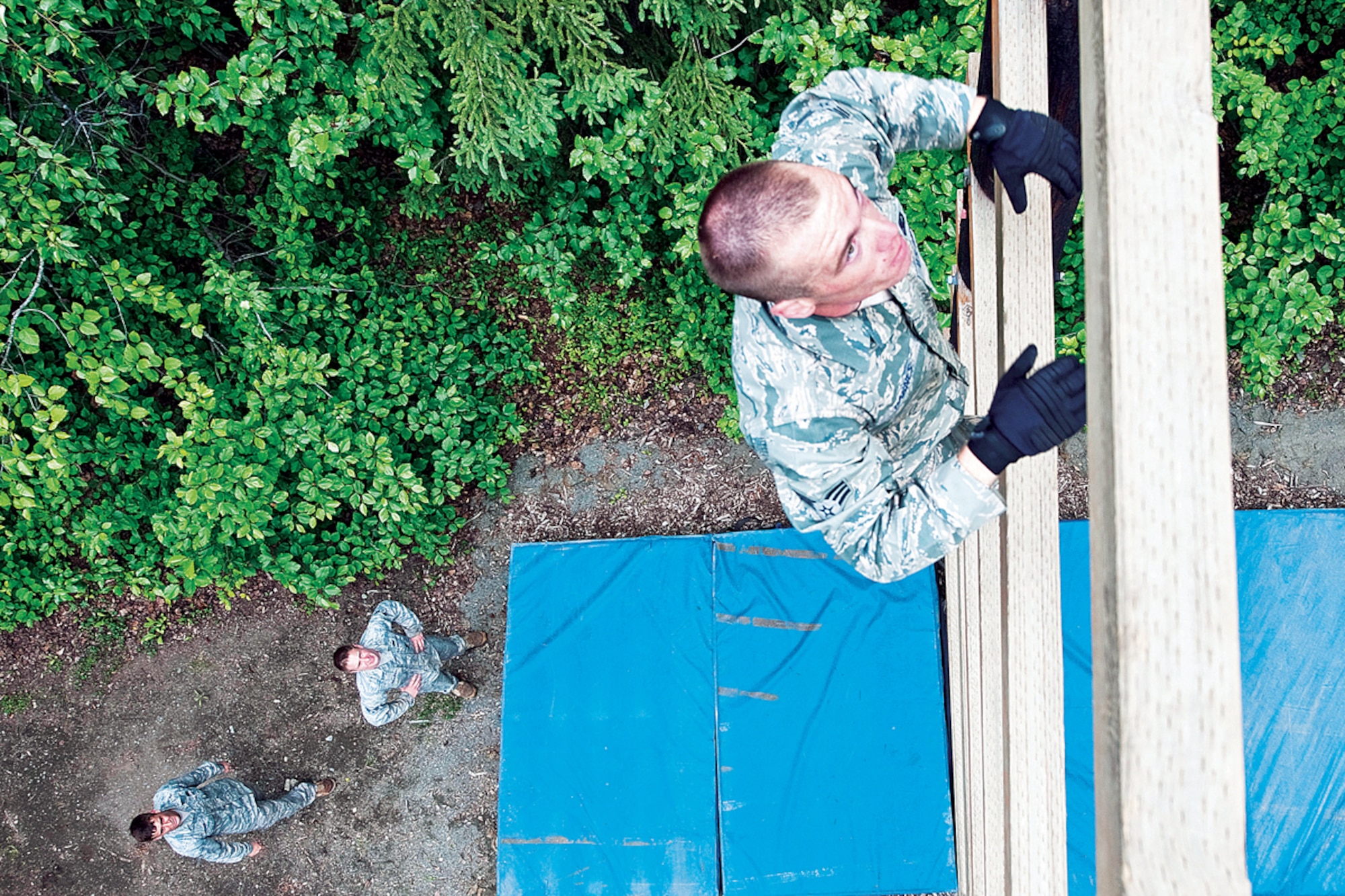Senior Airman Payton Barnes, 673d Security Forces Squadron, makes his way up an obstacle while his fellow Airmen watch from below during a training session, June 20. (U.S. Air Force photo/SRA Chris Gross)