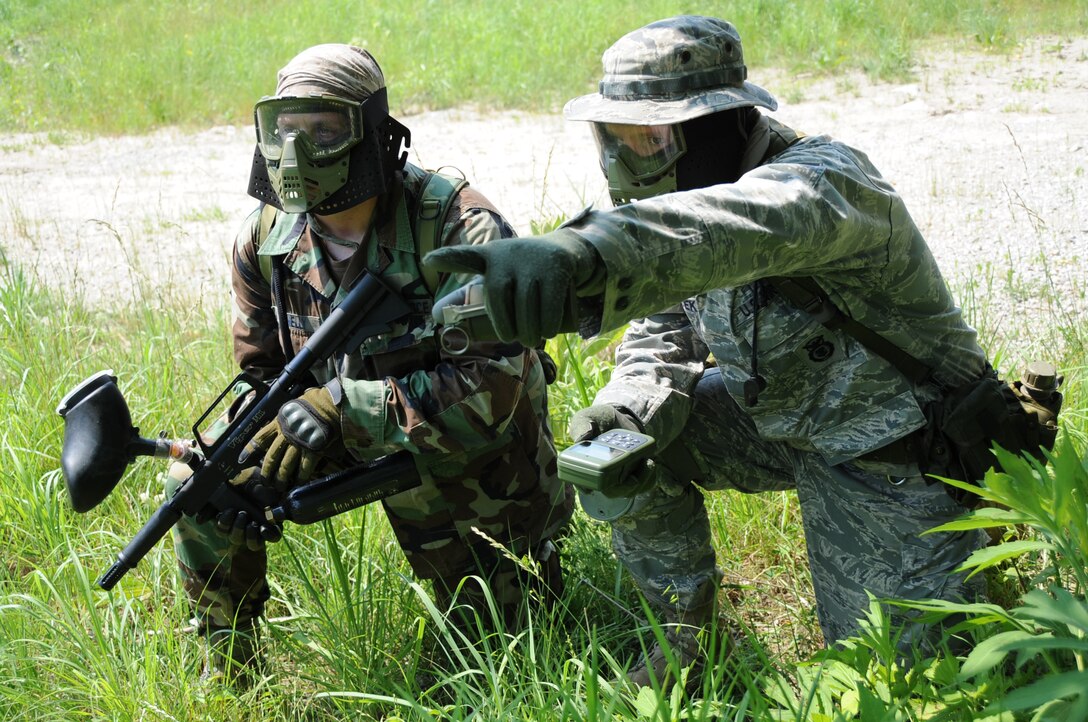 It’s That Way: Staff Sgt. Larry Hudecek, a fire team leader with the 155th Security Forces Squadron, points out where to go to Tech. Sgt. Joshua Dannelly, a second squad leader, during a paintball exercise in the 155th SFS’s field training exercise at Camp Ashland, Neb., June 8. 